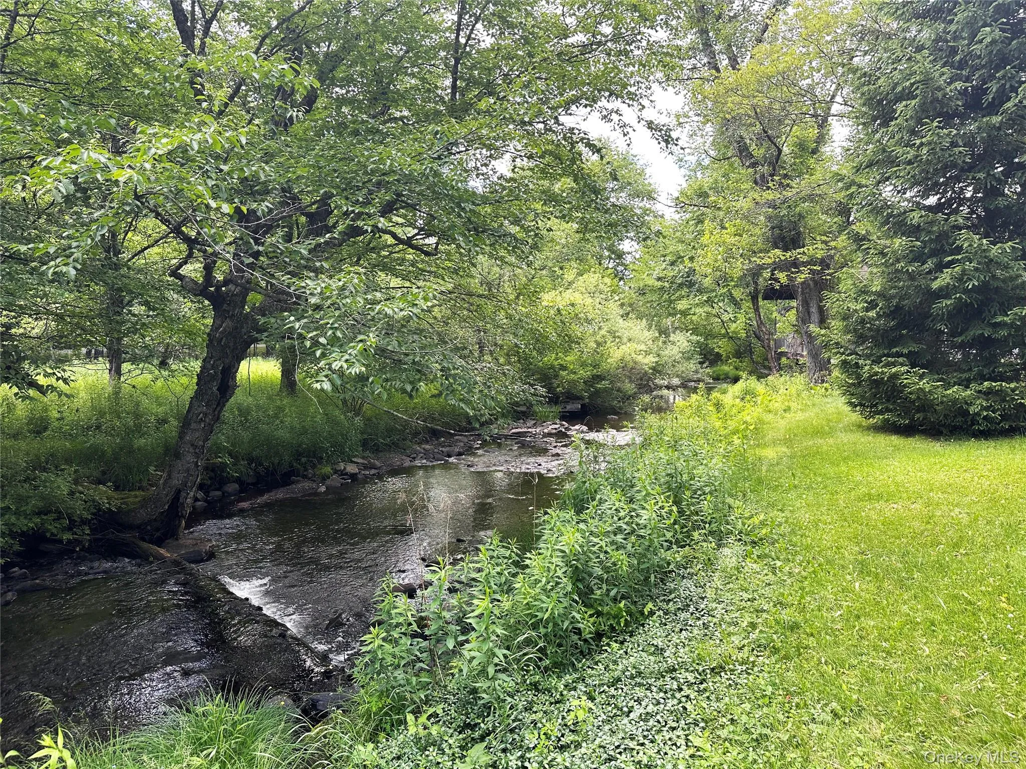 Trout Brook winding along the property boundary, offering a peaceful waterfront setting, scenic natural beauty, and renowned fly fishing opportunities. Trout Brook winding along the property boundary, offering a peaceful waterfront setting, scenic natural beauty, and renowned fly fishing opportunities.