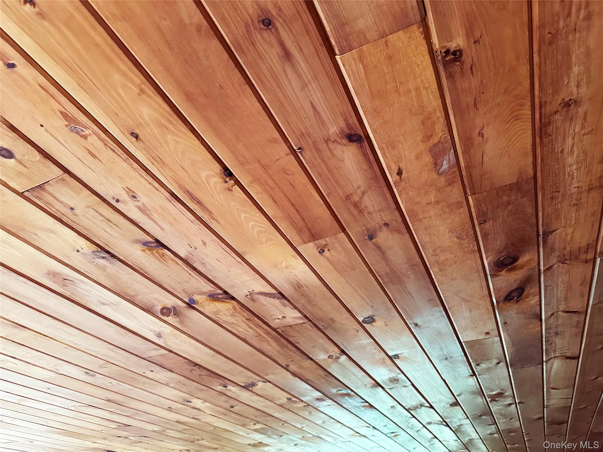 Original tongue-and-groove wood ceiling detail showcasing the home’s authentic Catskills cabin character and craftsmanship. Original tongue-and-groove wood ceiling detail showcasing the home’s authentic Catskills cabin character and craftsmanship.