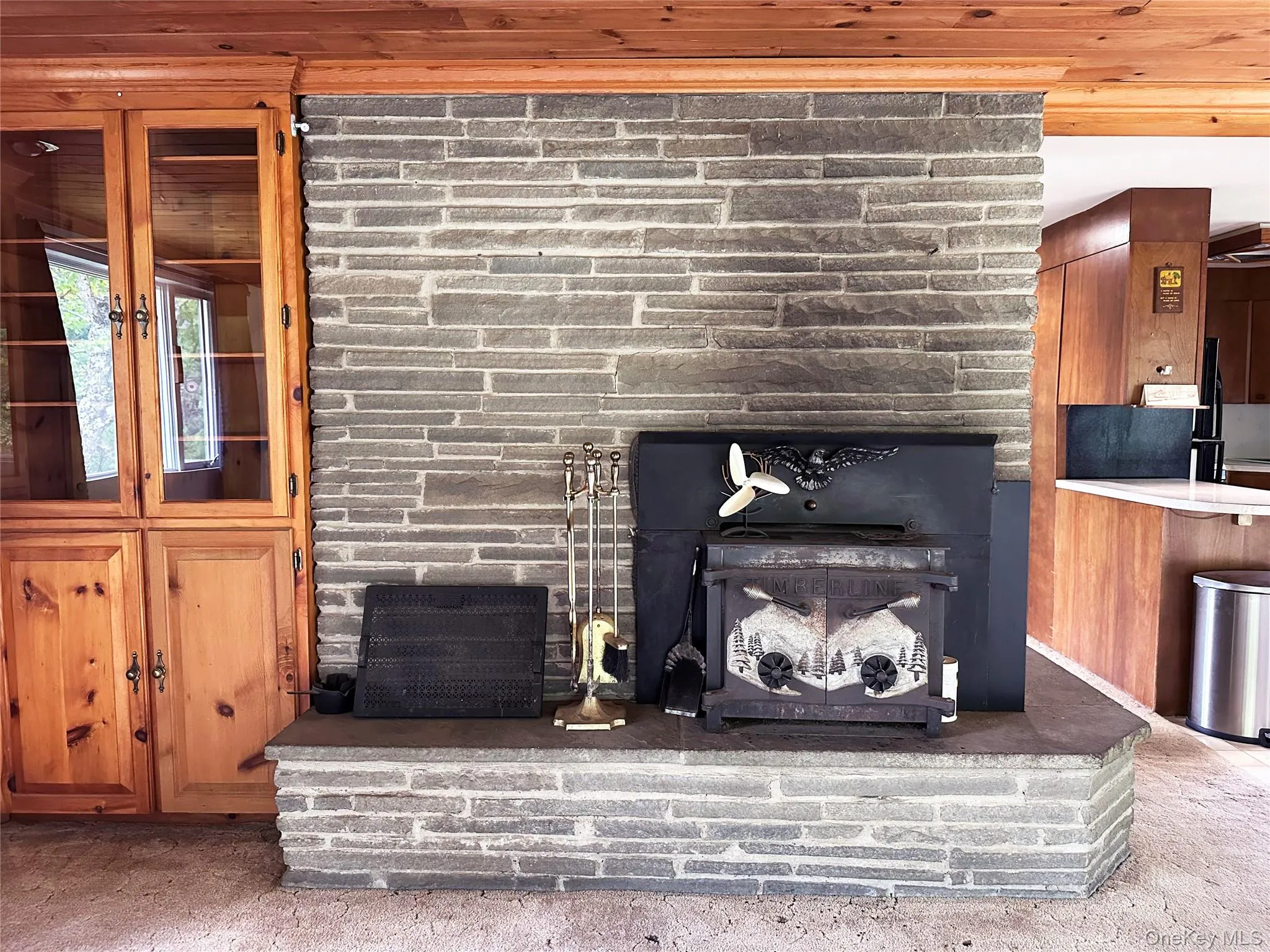 Central stone fireplace with integrated wood-burning stove designed for ambiance, cooking and supplemental heating. Central stone fireplace with integrated wood-burning stove designed for ambiance, cooking and supplemental heating.