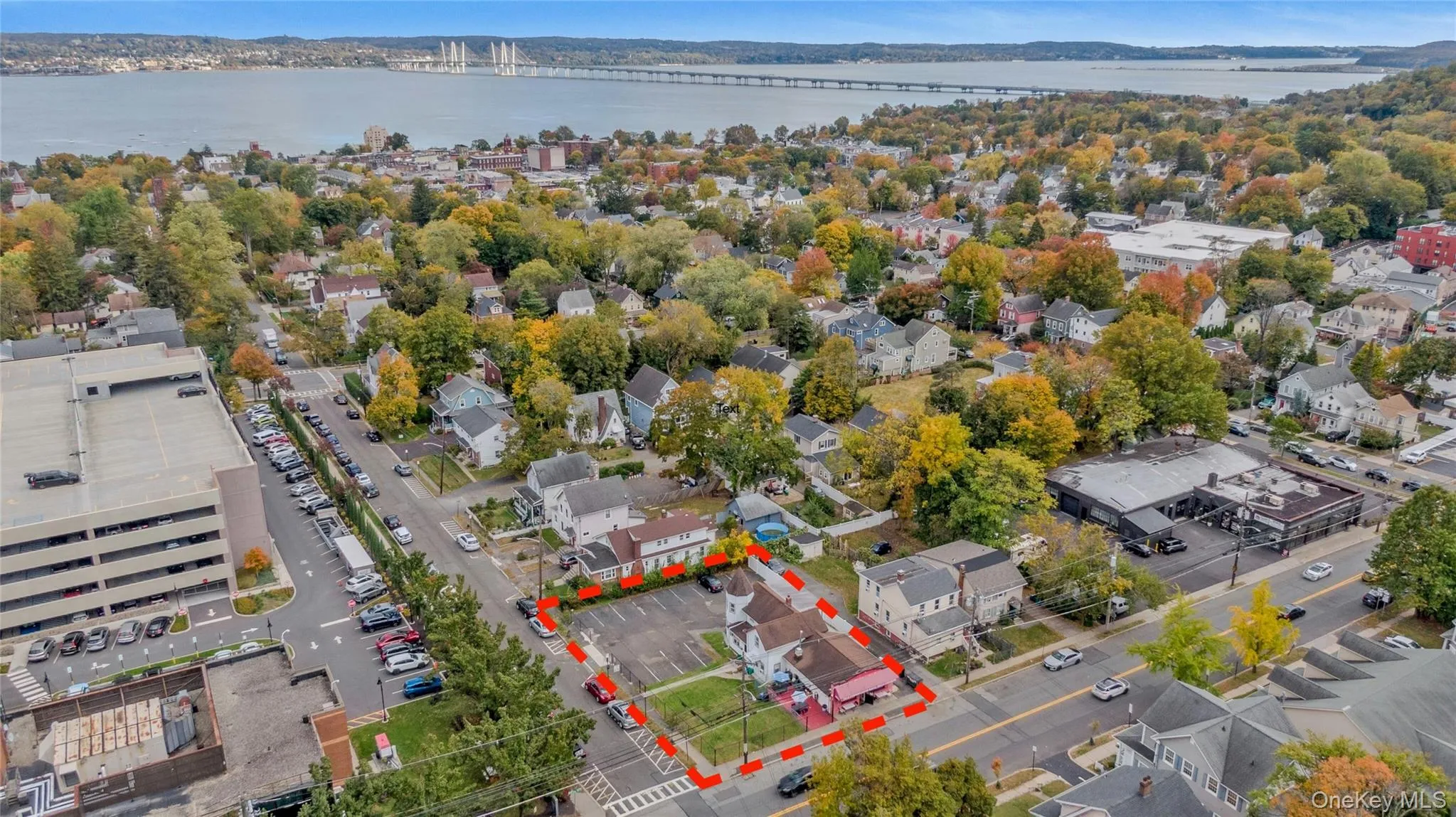 Aerial perspective of suburban area with a notable bridge and a nearby body of water Aerial perspective of suburban area with a notable bridge and a nearby body of water