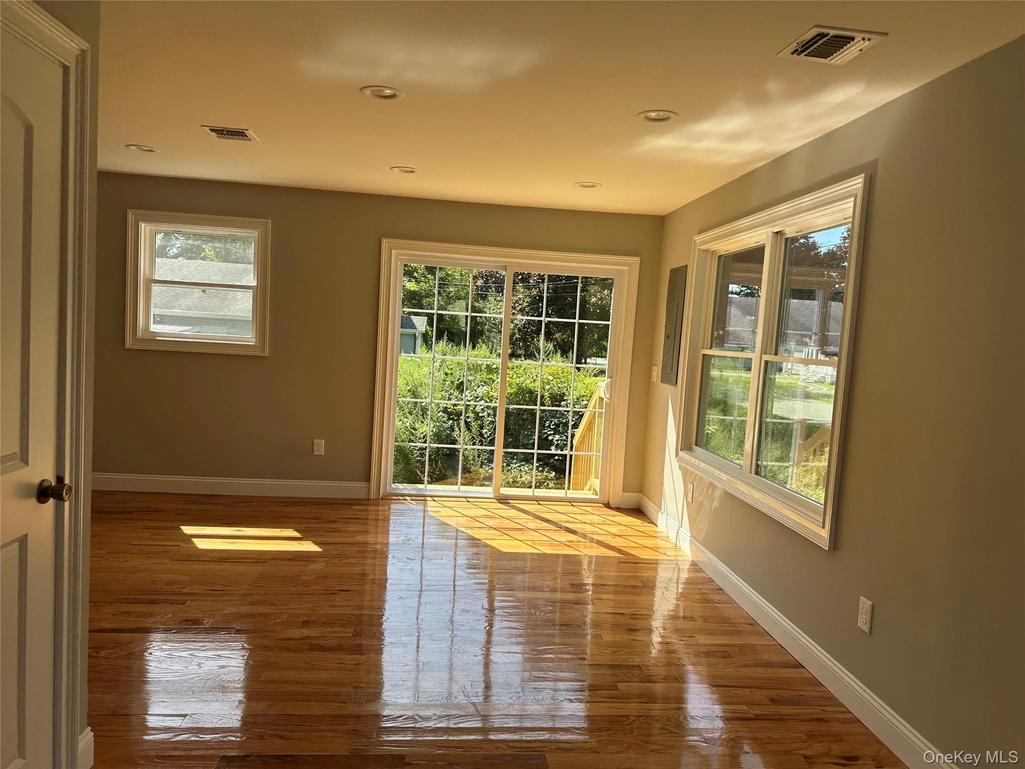1st Floor Family Room featuring wood-finish flooring, recessed lighting, and light gray wall tones 1st Floor Family Room featuring wood-finish flooring, recessed lighting, and light gray wall tones