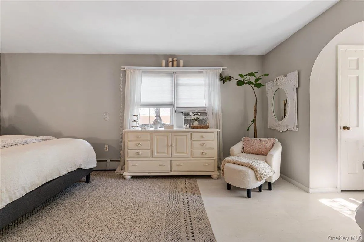 Spacious room featuring neutral painted walls and a light-toned area rug over a lighter floor Spacious room featuring neutral painted walls and a light-toned area rug over a lighter floor
