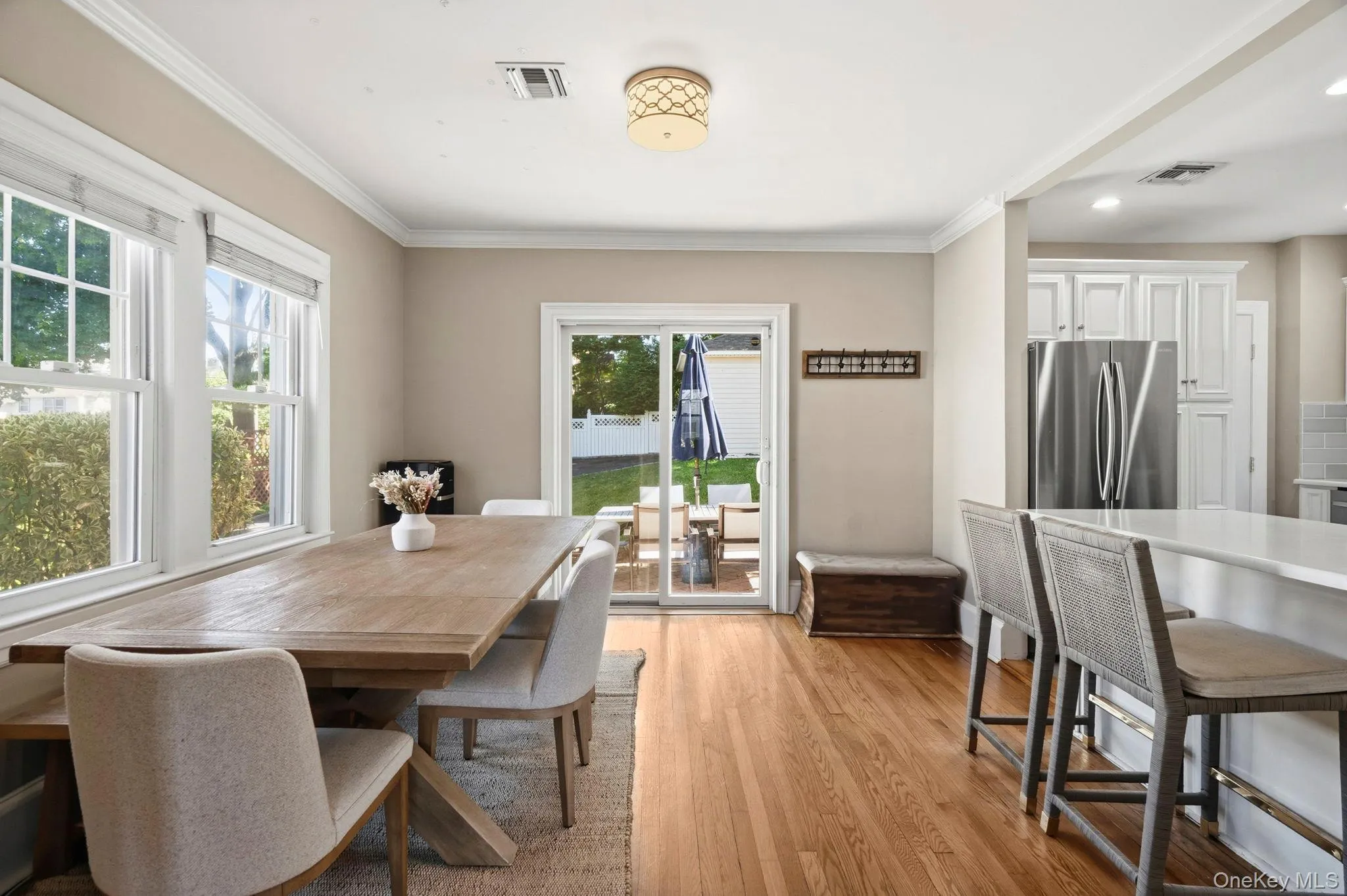 Dining area with wood-finish flooring and crown molding Dining area with wood-finish flooring and crown molding