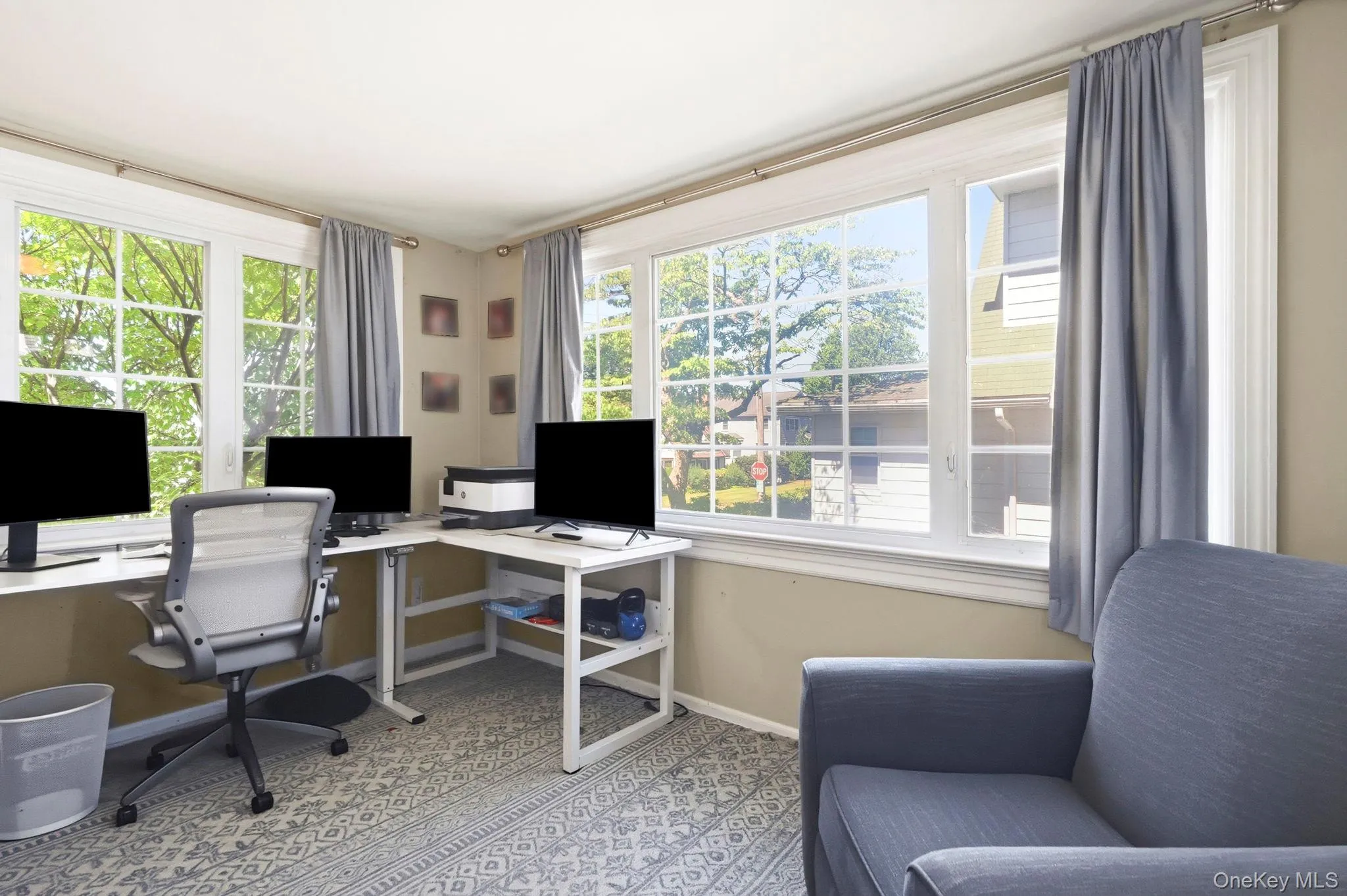 Light-filled room featuring multiple large windows with white muntins Light-filled room featuring multiple large windows with white muntins