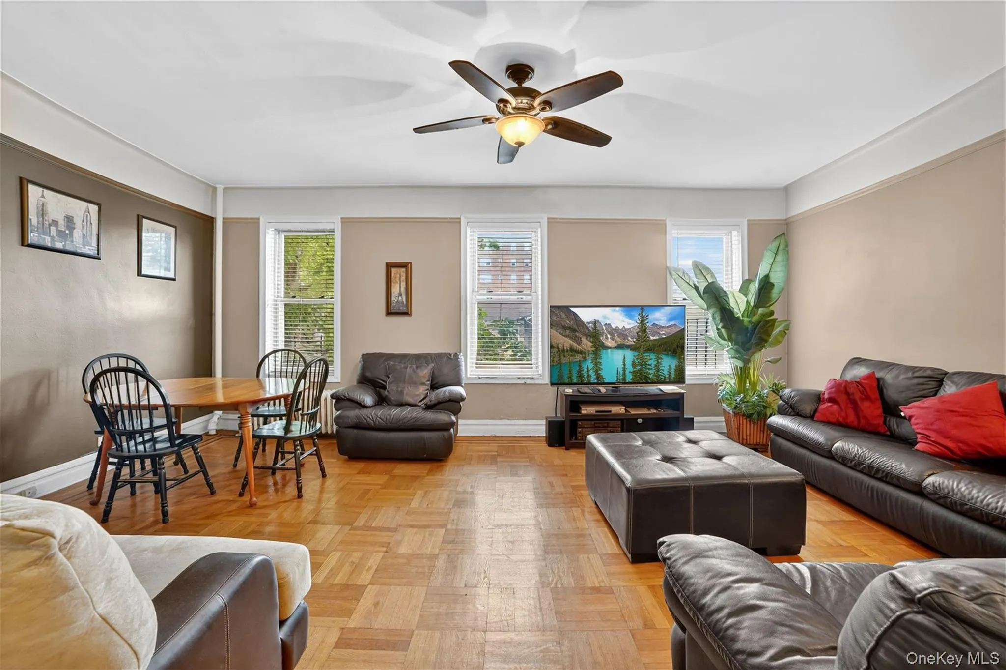 Living room with a ceiling fan and baseboards Living room with a ceiling fan and baseboards