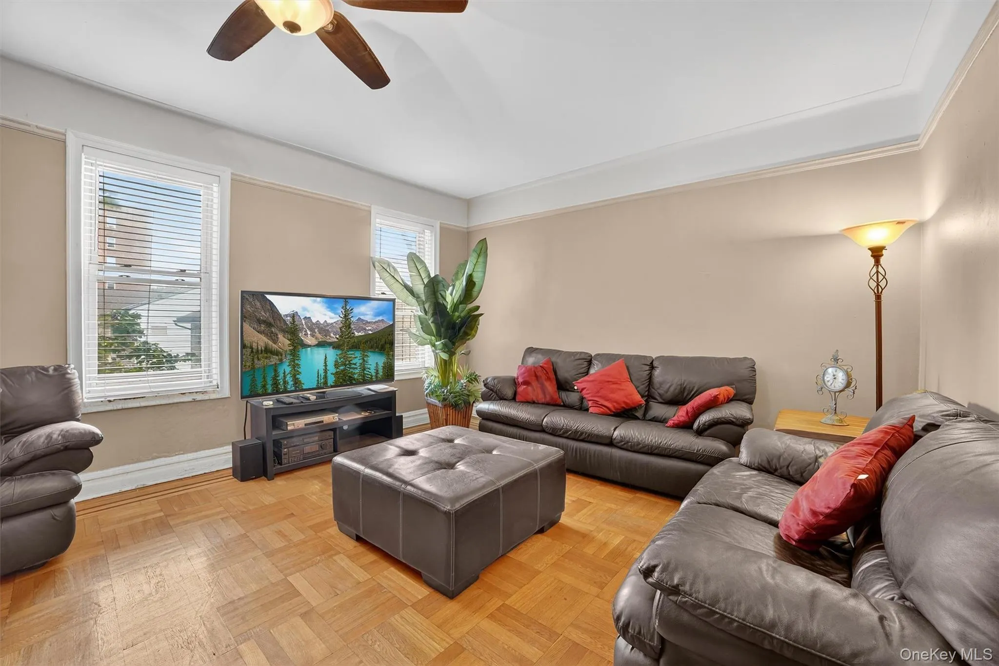Living area featuring ceiling fan and baseboards Living area featuring ceiling fan and baseboards