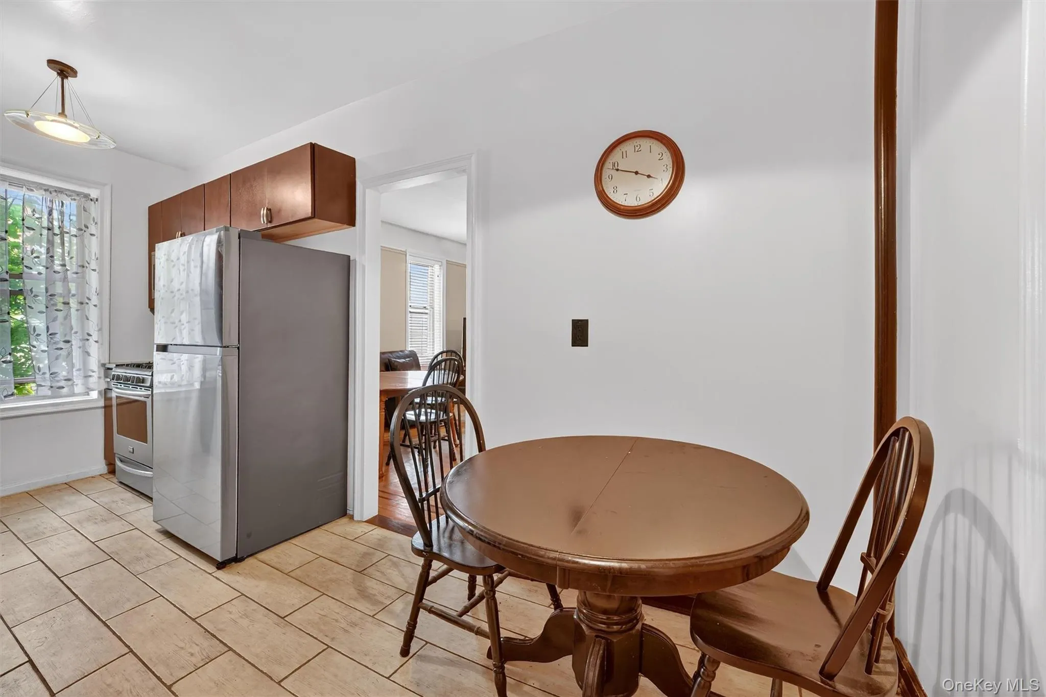 Kitchen with appliances with stainless steel finishes and brown cabinetry Kitchen with appliances with stainless steel finishes and brown cabinetry