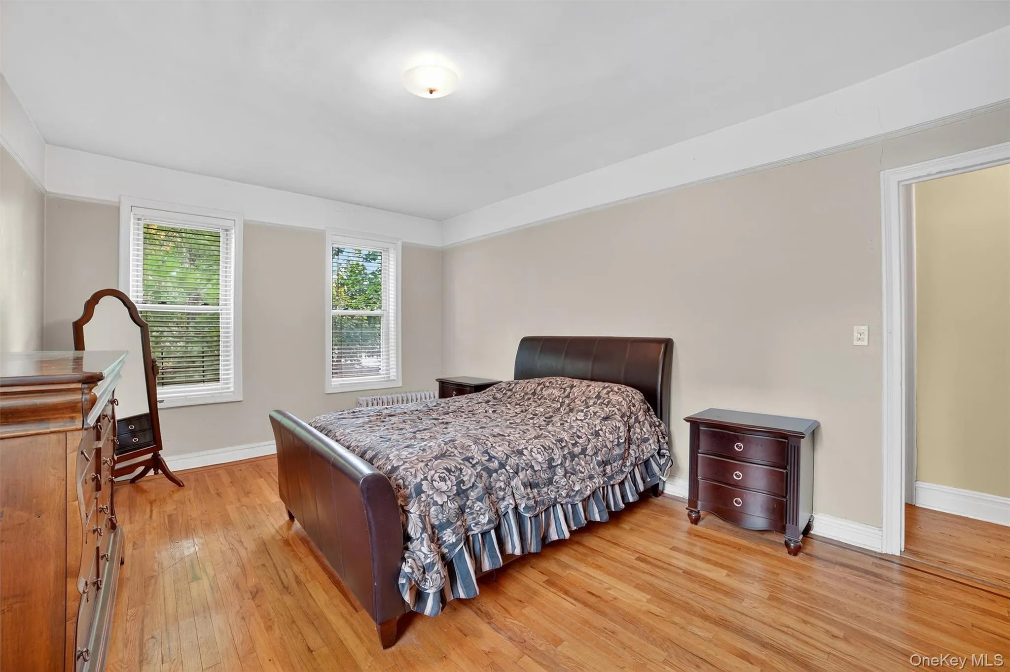 Bedroom featuring light wood-type flooring and baseboards Bedroom featuring light wood-type flooring and baseboards