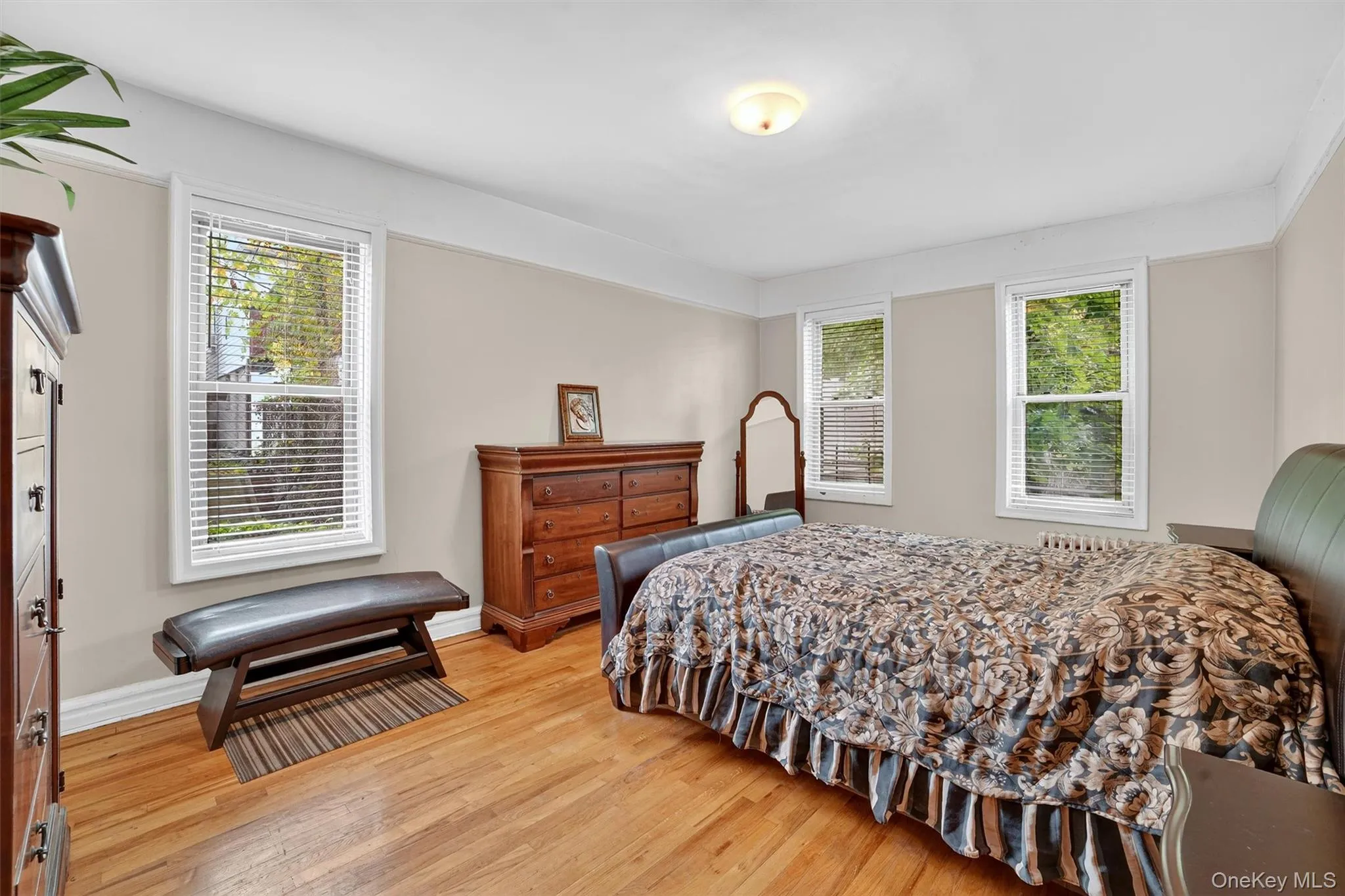 Bedroom featuring light wood finished floors and baseboards Bedroom featuring light wood finished floors and baseboards