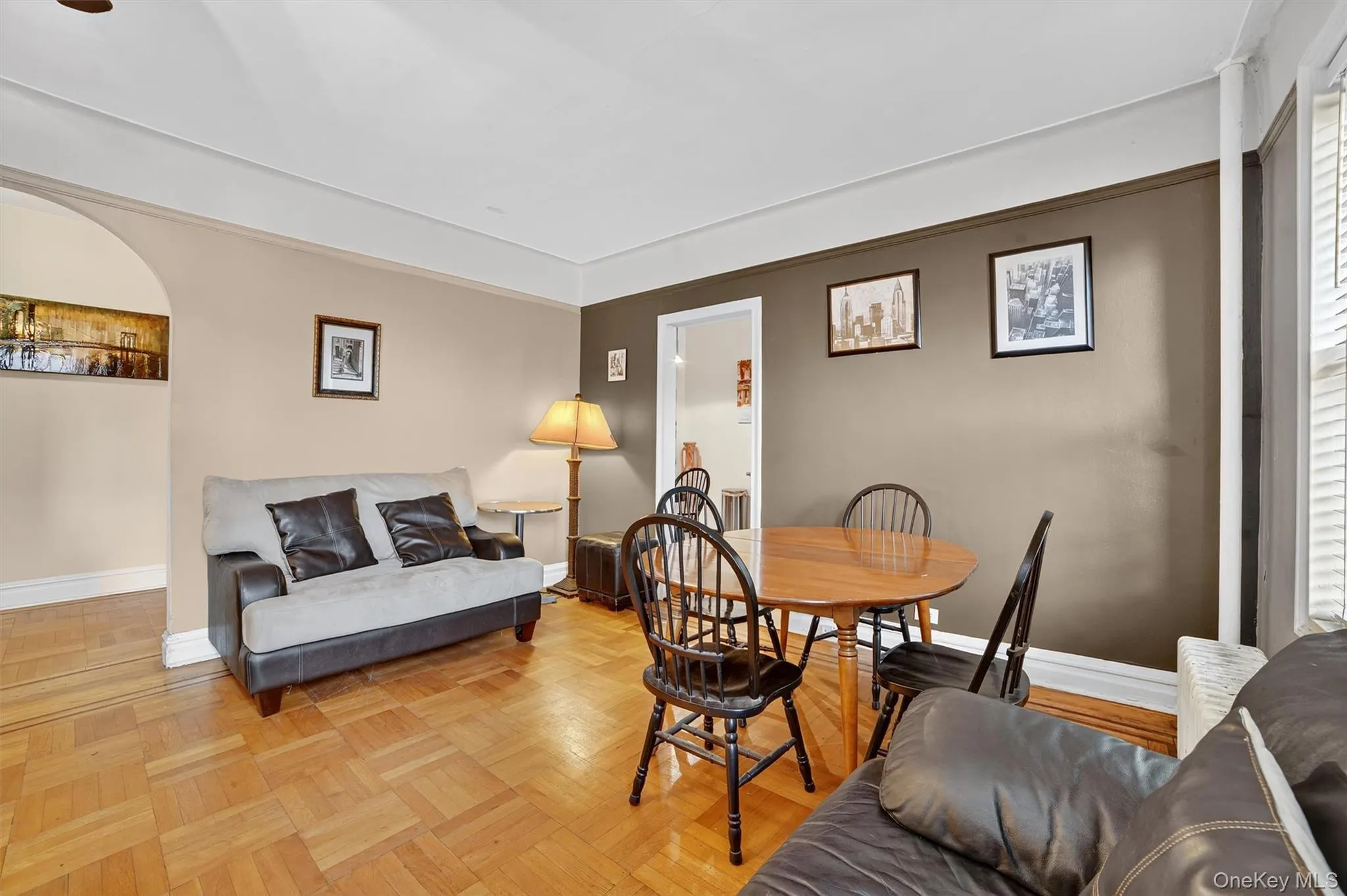 Dining area with baseboards and arched walkways Dining area with baseboards and arched walkways