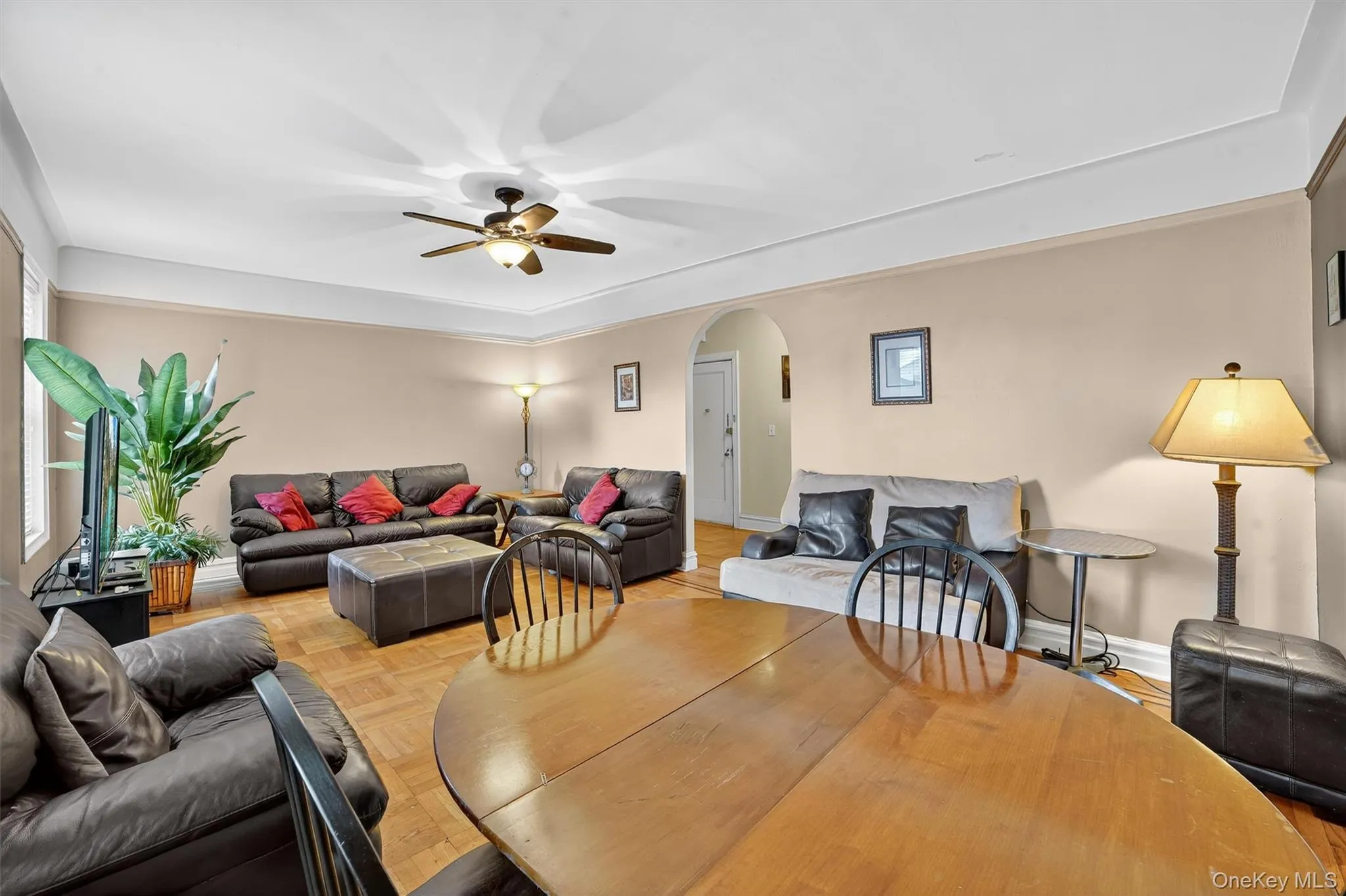 Dining space featuring arched walkways and ceiling fan Dining space featuring arched walkways and ceiling fan