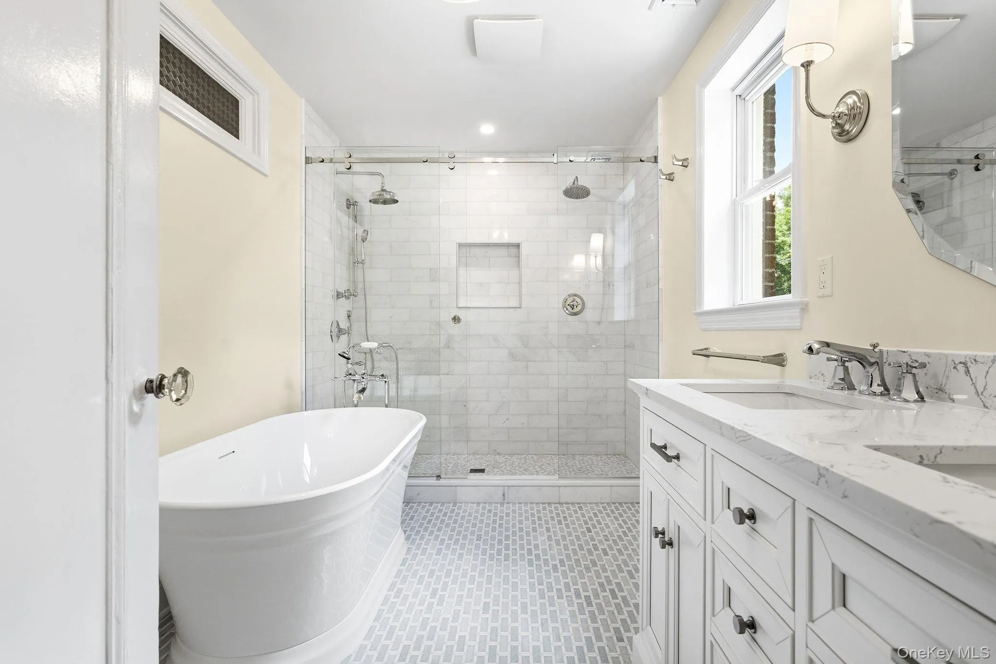 Enjoy a soaking tub, expansive glass shower, and refined finishes. Enjoy a soaking tub, expansive glass shower, and refined finishes.