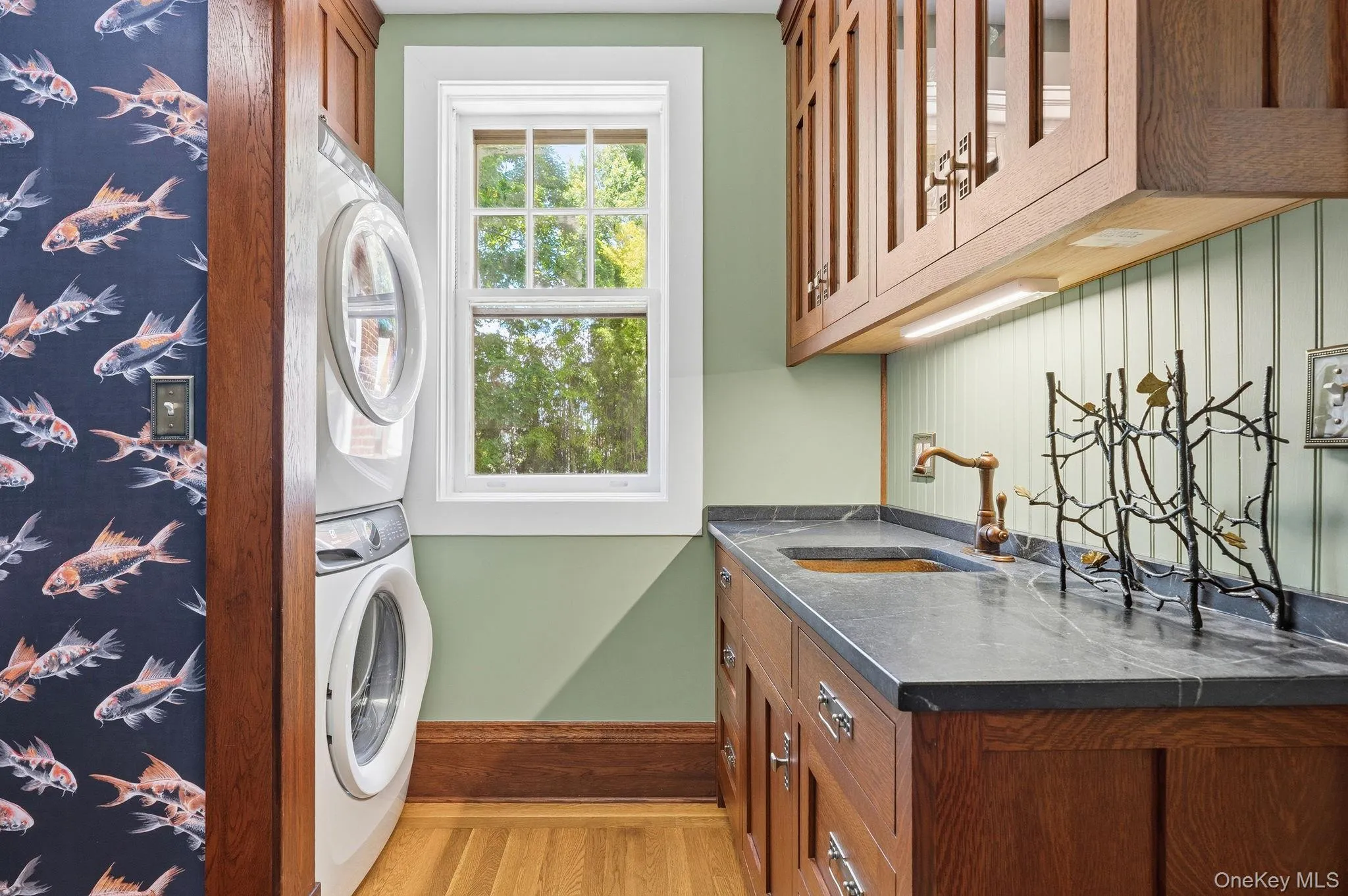 A spacious laundry room paired with an entertaining wet bar. A spacious laundry room paired with an entertaining wet bar.
