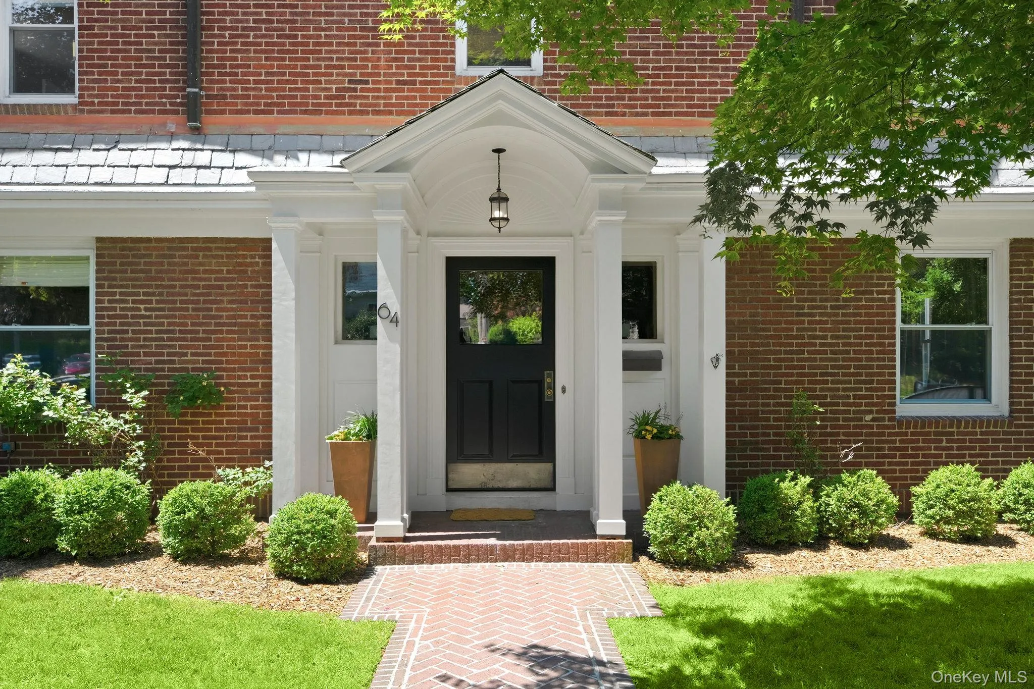 A stately columned entrance welcomes you home with timeless elegance. A stately columned entrance welcomes you home with timeless elegance.