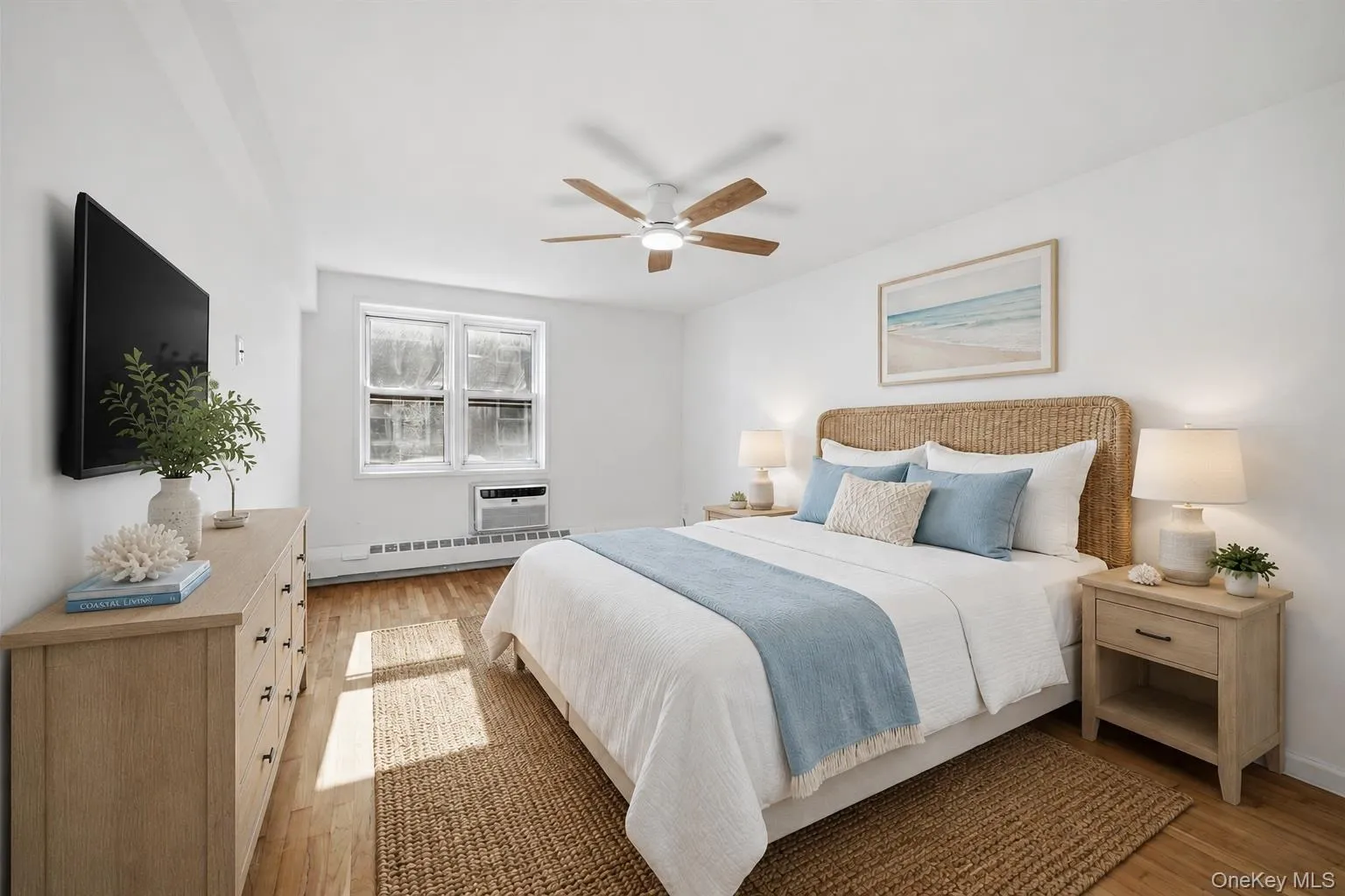 Bedroom featuring two windows, and an in-wall AC unitThis photo was virtually staged Bedroom featuring two windows, and an in-wall AC unitThis photo was virtually staged