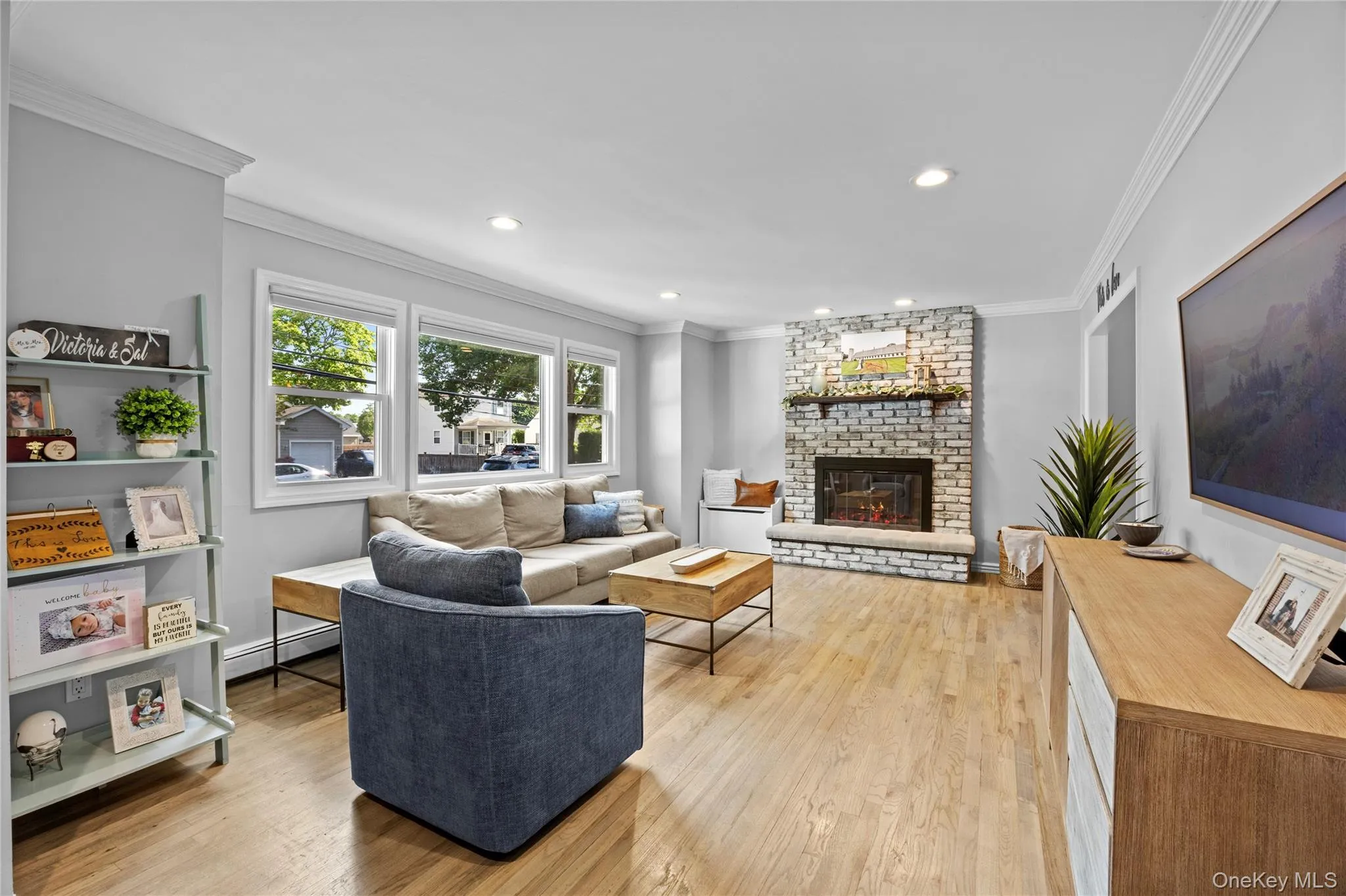 Light and bright living room with picture window and fireplace Light and bright living room with picture window and fireplace