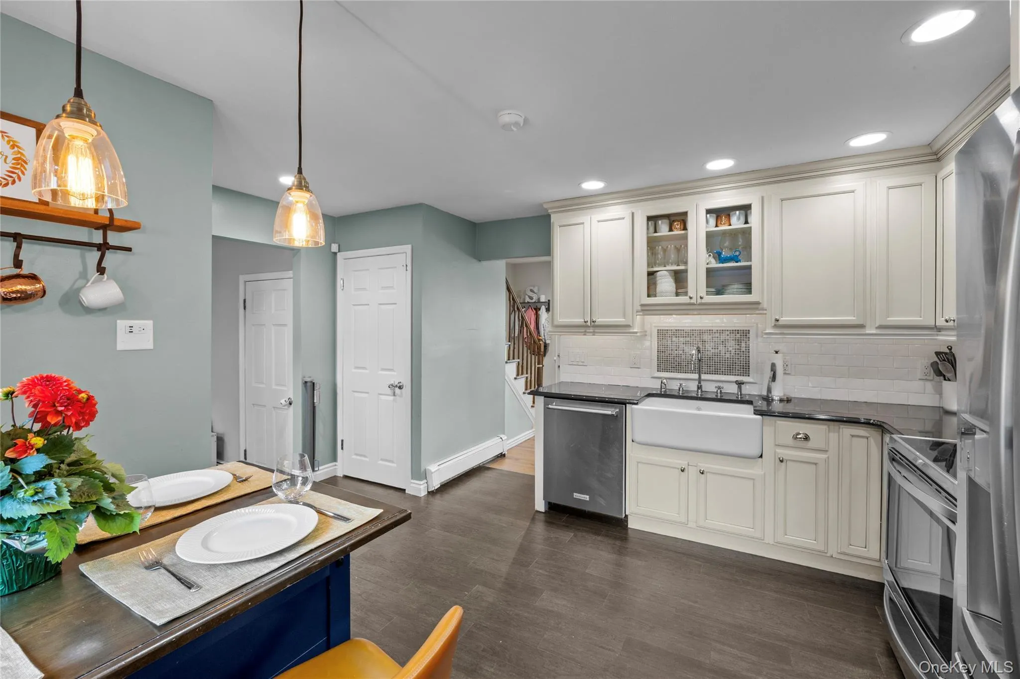Kitchen featuring access to front door and living room area along with den and dining room Kitchen featuring access to front door and living room area along with den and dining room