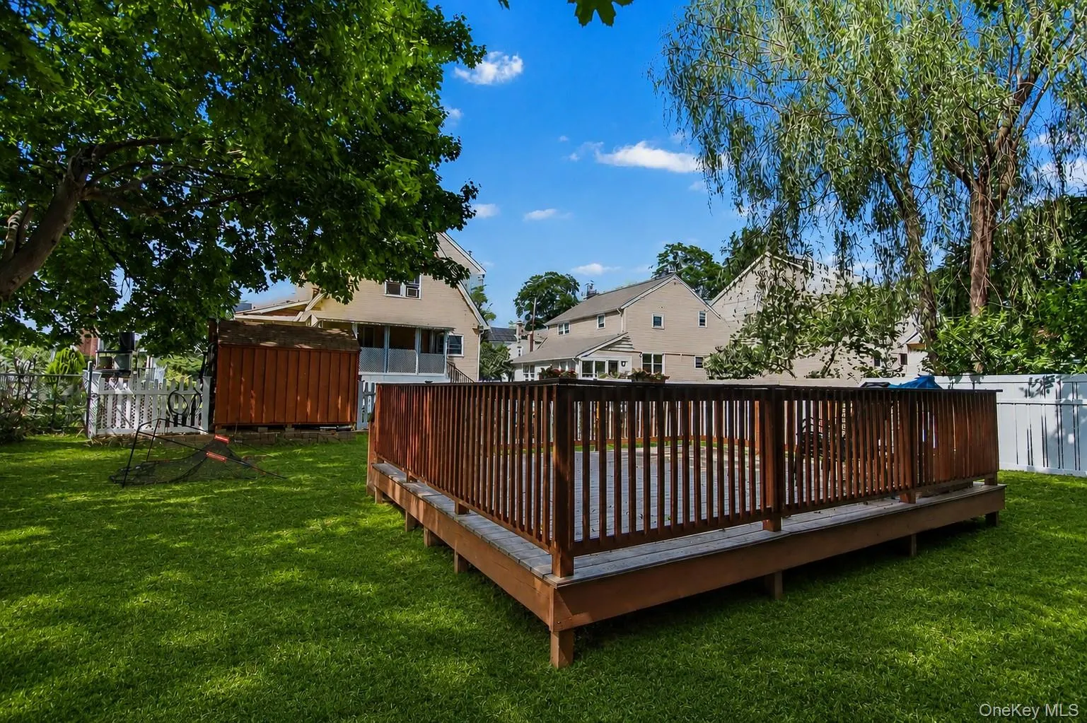 Private, level backyard with large wood deck. Private, level backyard with large wood deck.