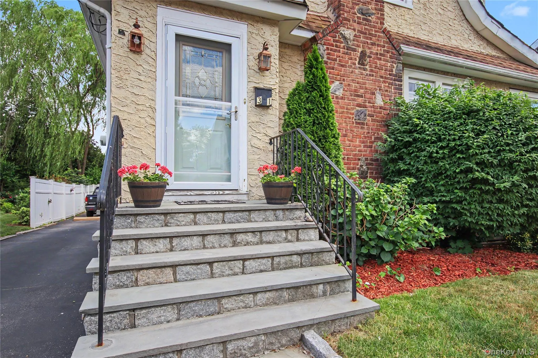 Blue stone steps and pavers leading to front door. Blue stone steps and pavers leading to front door.