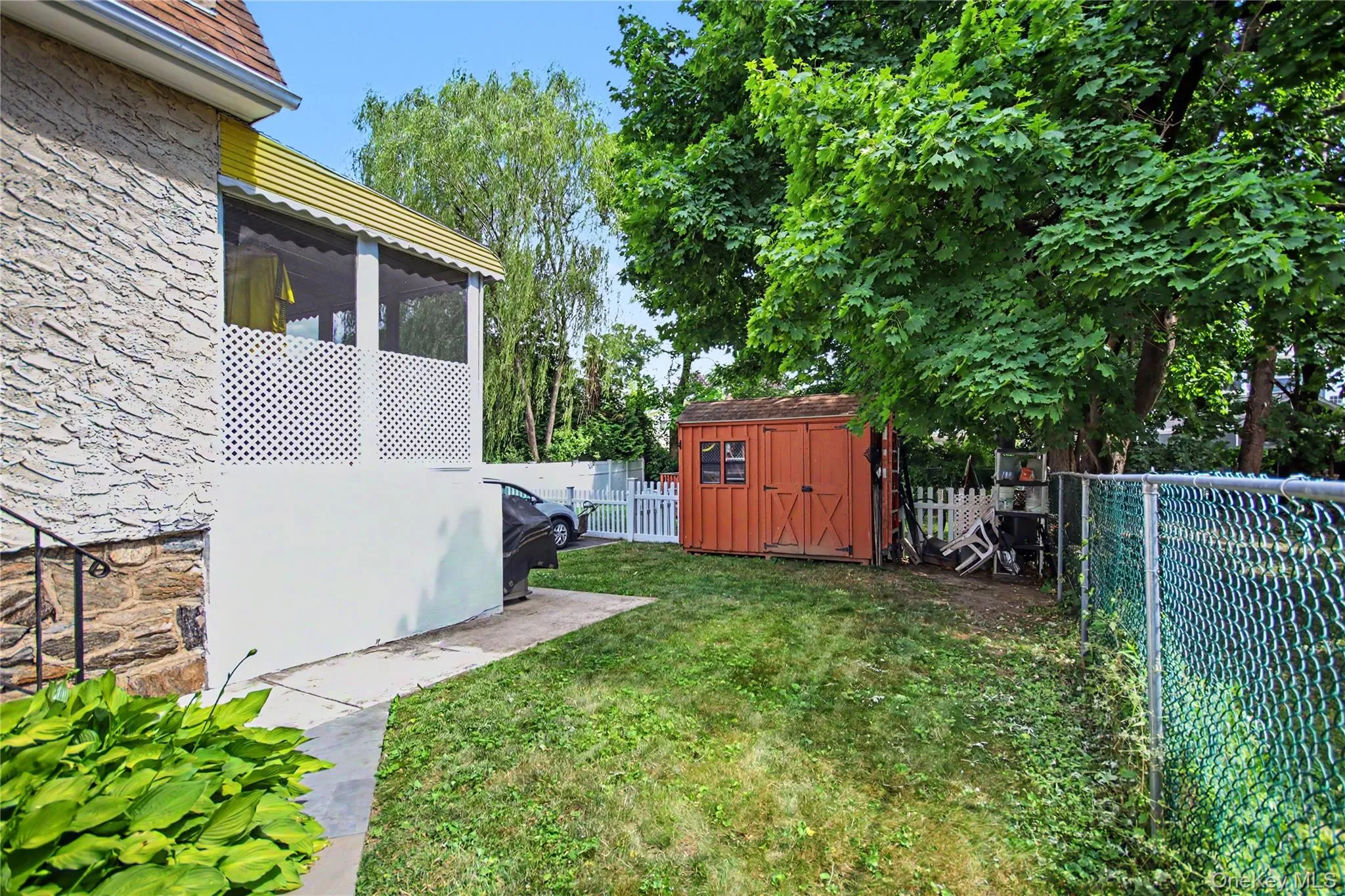 View of side yard with walk to bonus room. View of side yard with walk to bonus room.
