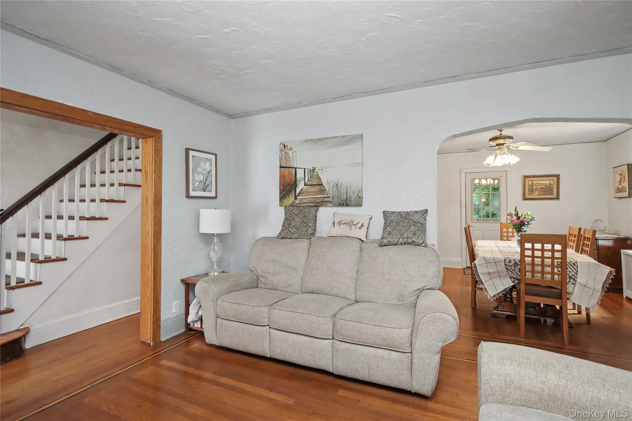 Living room looking onto formal dining room and stairs. Living room looking onto formal dining room and stairs.