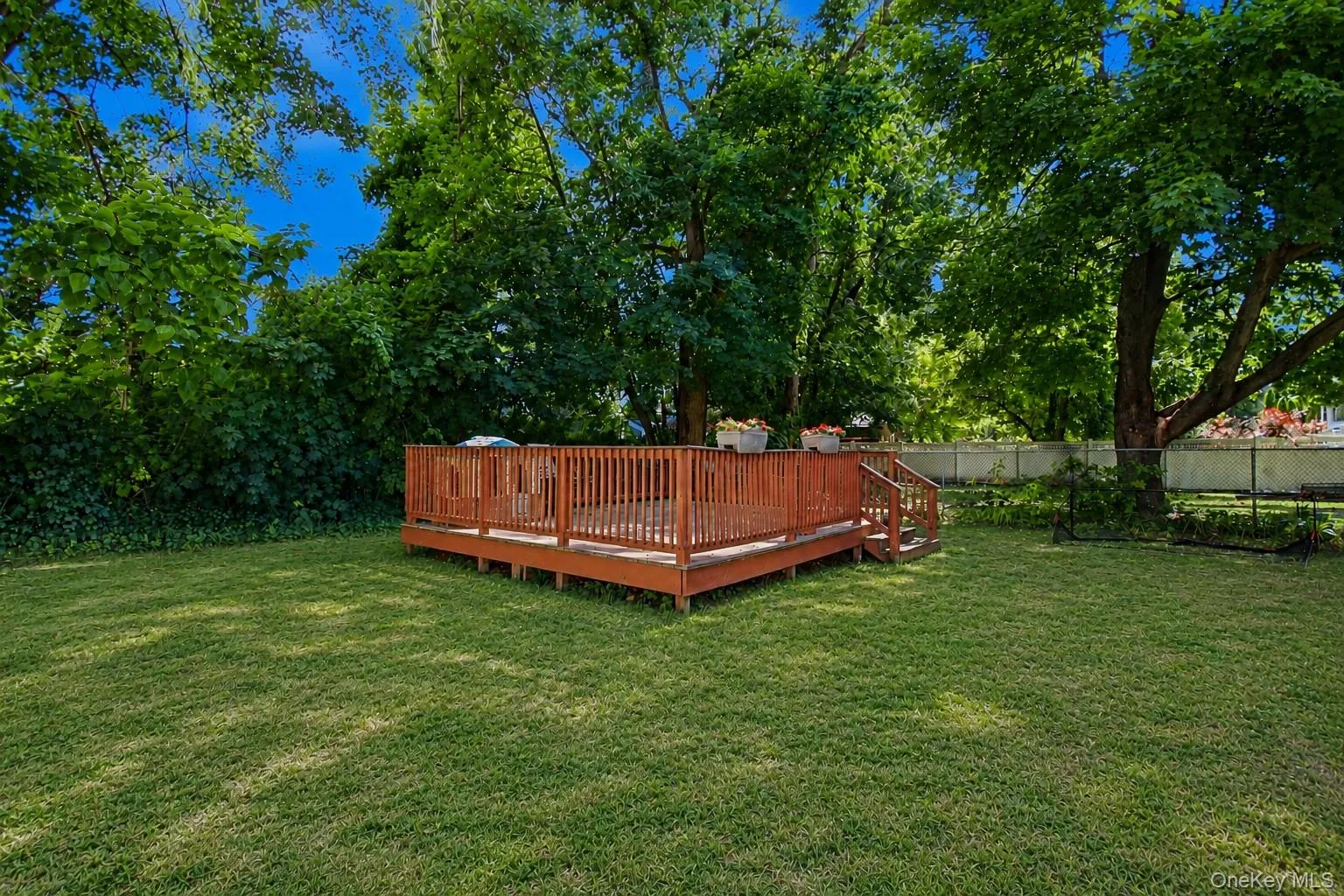 Private, level backyard with large wood deck. Private, level backyard with large wood deck.