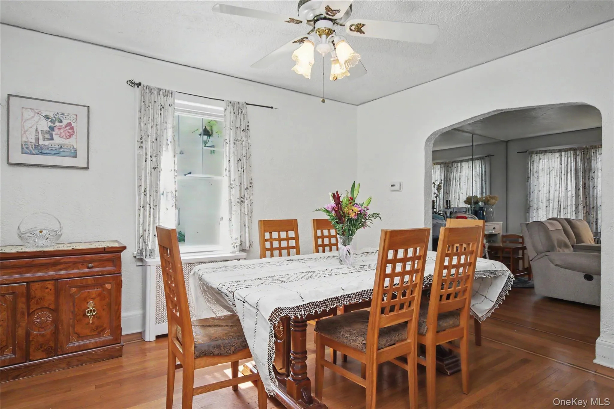 Formal dining room with architectural arch into living room. Formal dining room with architectural arch into living room.
