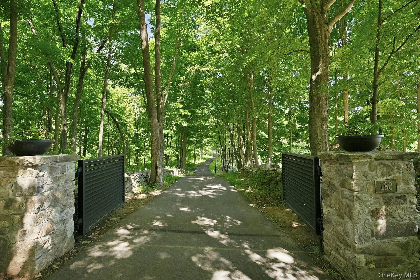 Automated steelgated ½ mile long paved driveway provides both a secure entrance and a meandering romanticdrive to the interior compound Automated steelgated ½ mile long paved driveway provides both a secure entrance and a meandering romanticdrive to the interior compound