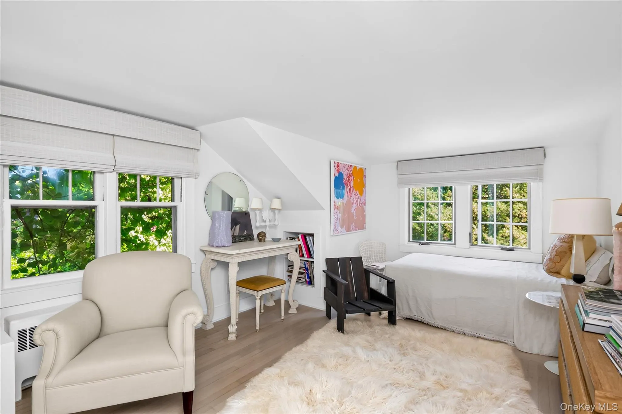 Bright interior featuring light wood-finish flooring, white walls, and multiple windows Bright interior featuring light wood-finish flooring, white walls, and multiple windows