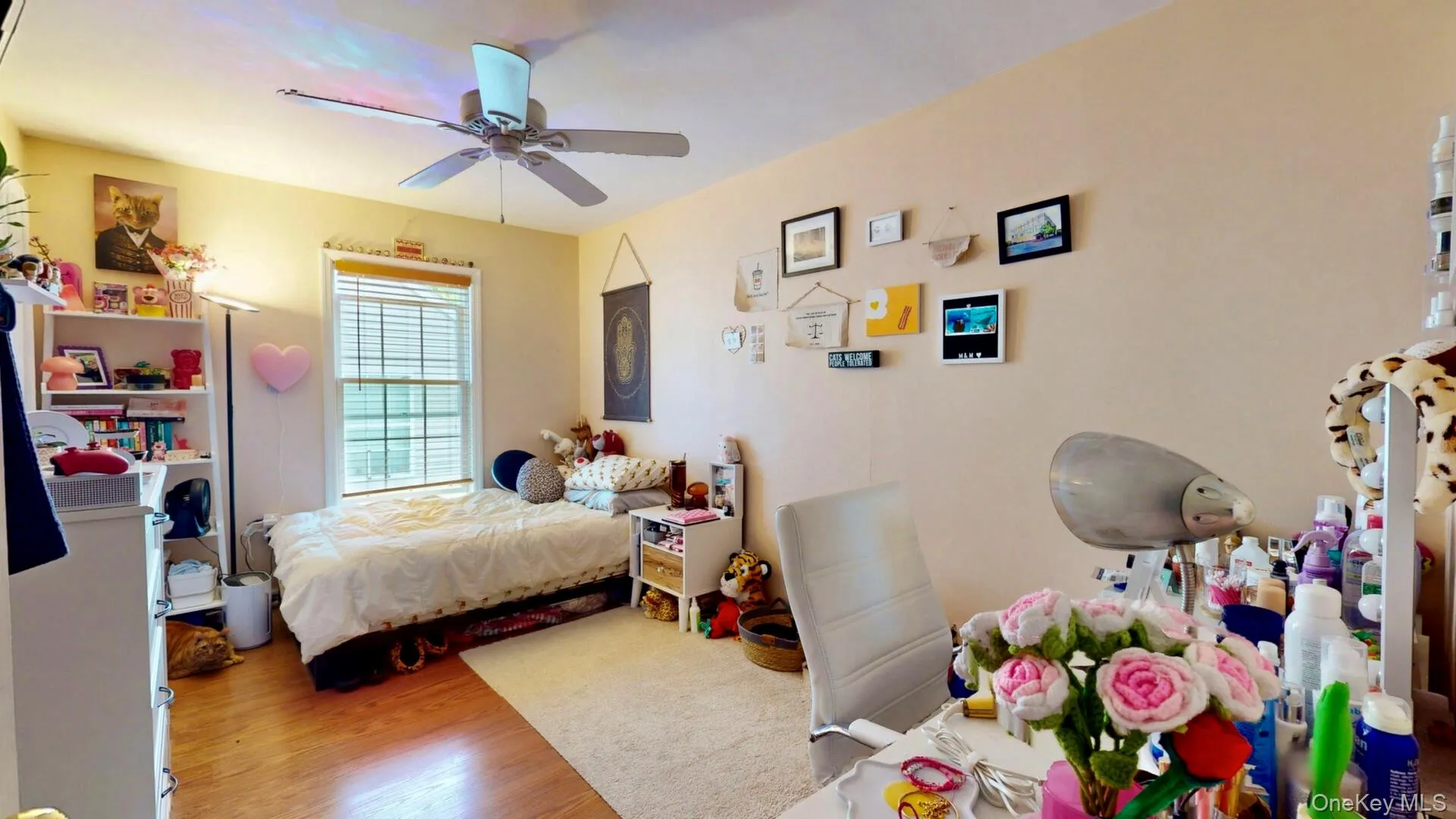 Bedroom with wood finished floors and a ceiling fan Bedroom with wood finished floors and a ceiling fan