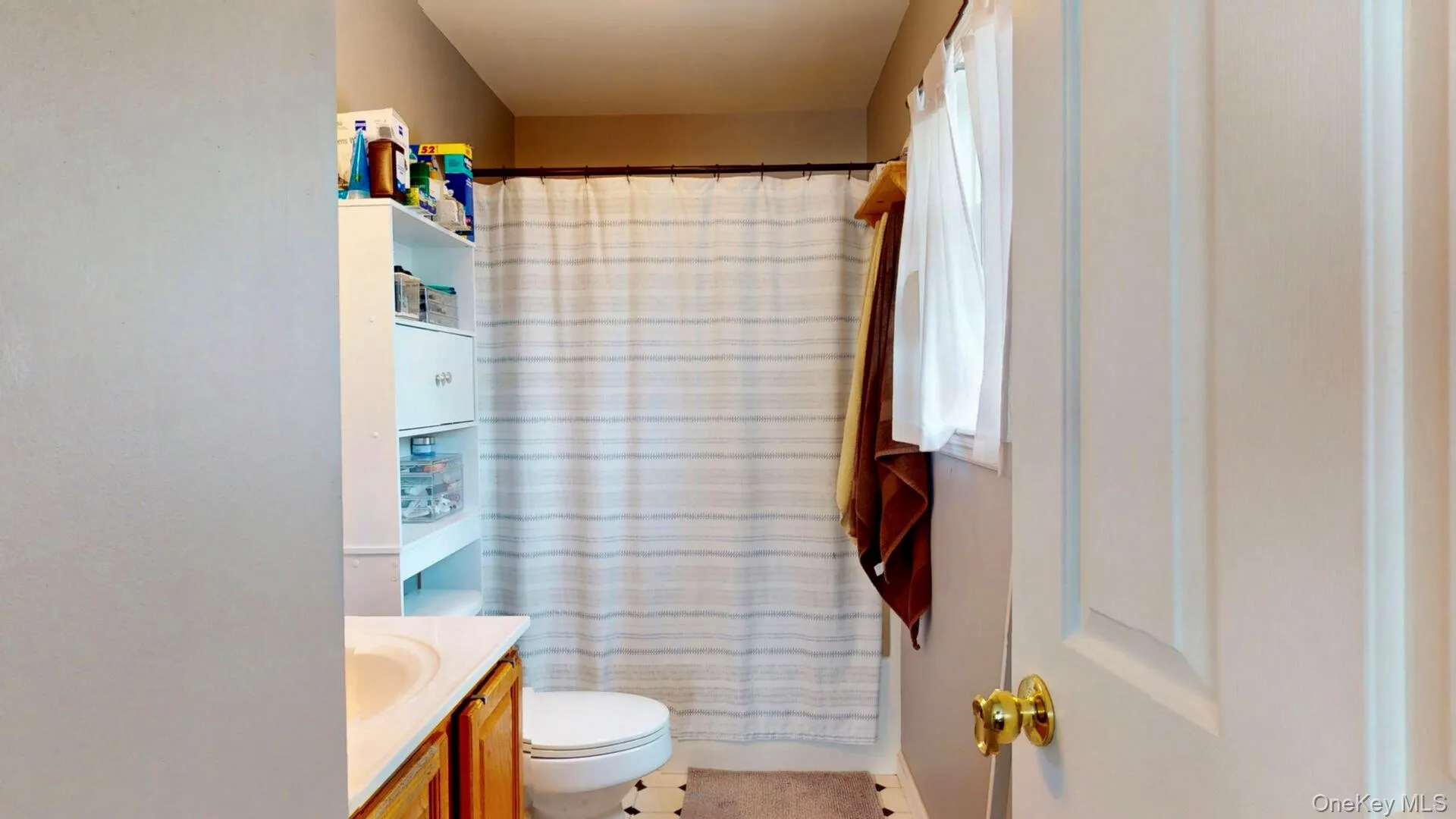 Full bathroom featuring vanity, toilet, and a shower with shower curtain Full bathroom featuring vanity, toilet, and a shower with shower curtain