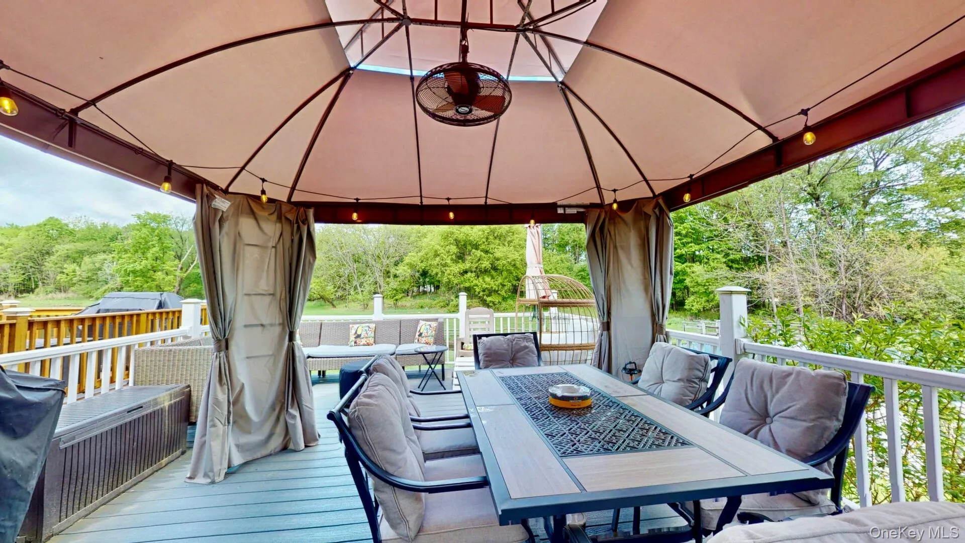 Wooden terrace featuring a gazebo, outdoor dining space, and outdoor lounge area Wooden terrace featuring a gazebo, outdoor dining space, and outdoor lounge area