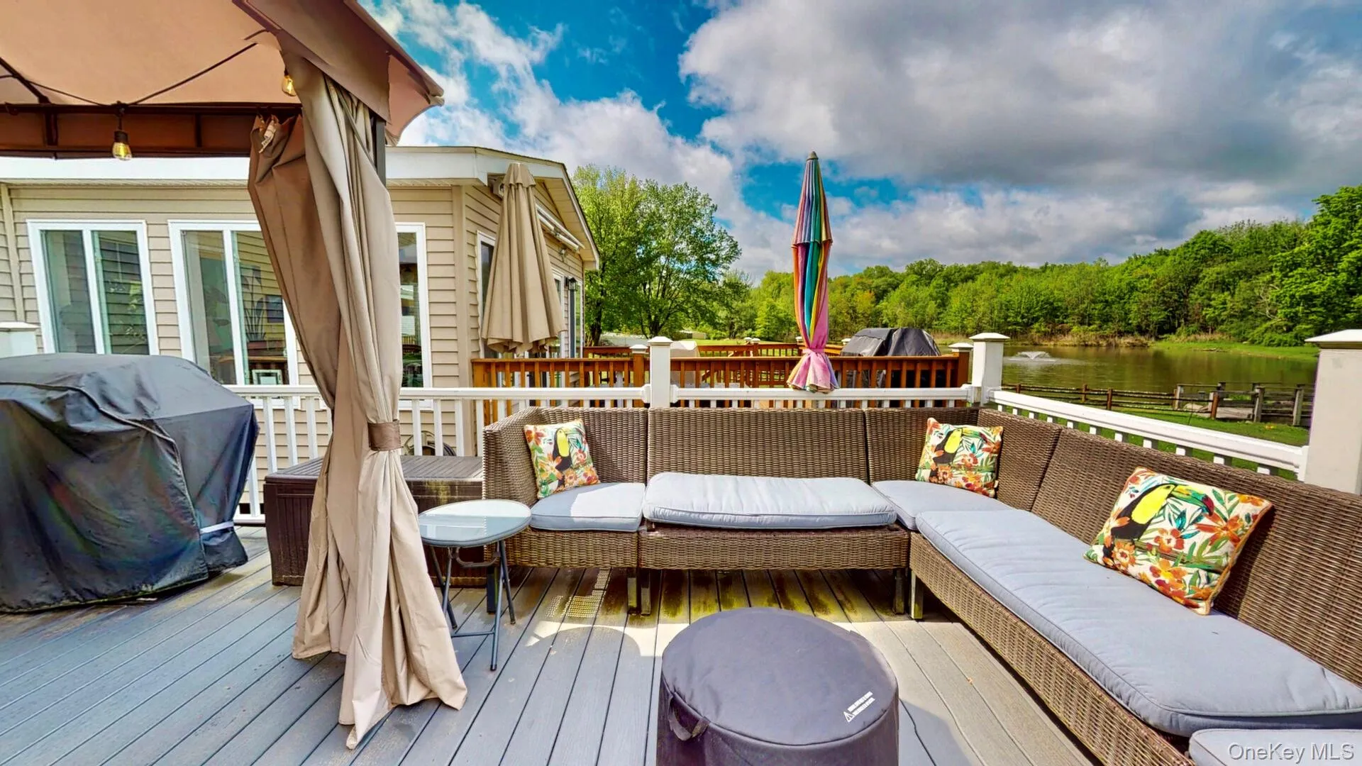Wooden deck with outdoor lounge area, a water view, and area for grilling Wooden deck with outdoor lounge area, a water view, and area for grilling