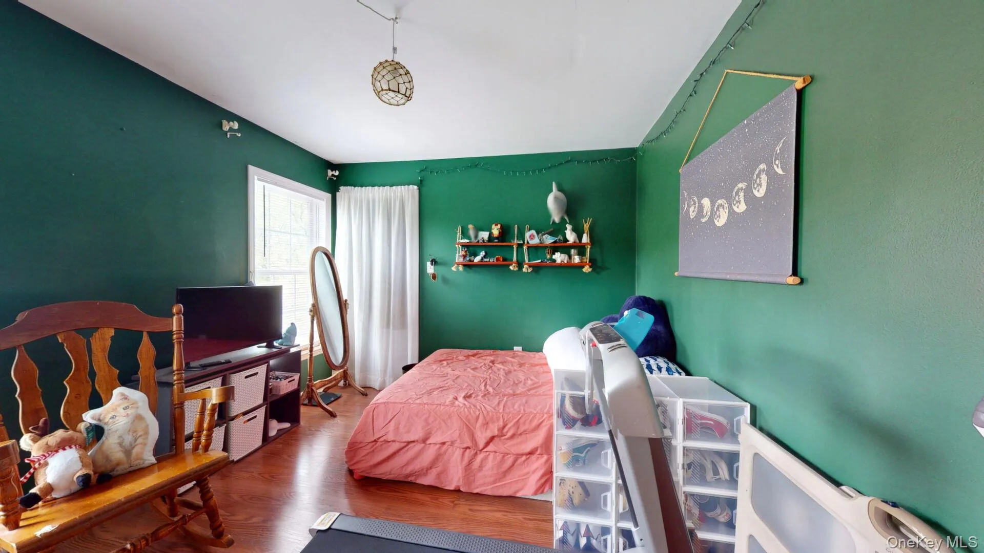 Bedroom featuring wood finished floors and lofted ceiling Bedroom featuring wood finished floors and lofted ceiling