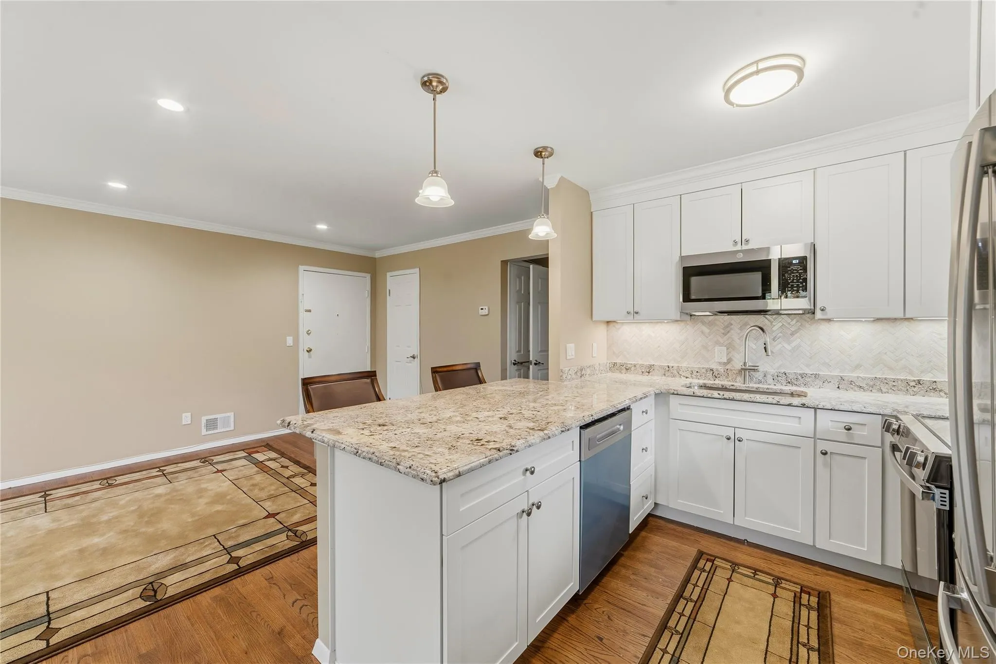 Stunning kitchen with all the latest touches. Herringbone style elegant backsplash matching granite countertop. Stunning kitchen with all the latest touches. Herringbone style elegant backsplash matching granite countertop.