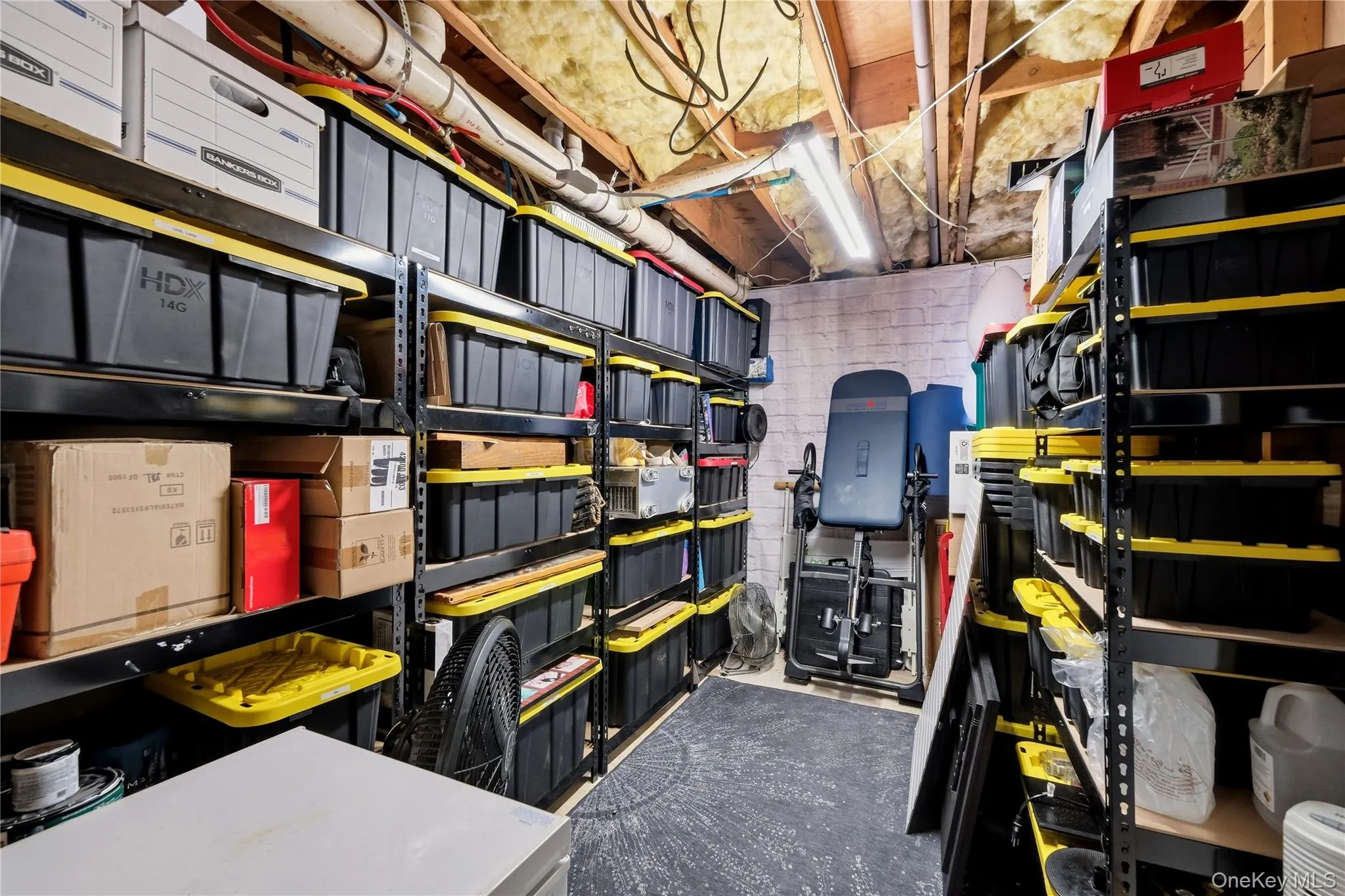 Dedicated storage room with exposed ceiling joists and insulation Dedicated storage room with exposed ceiling joists and insulation