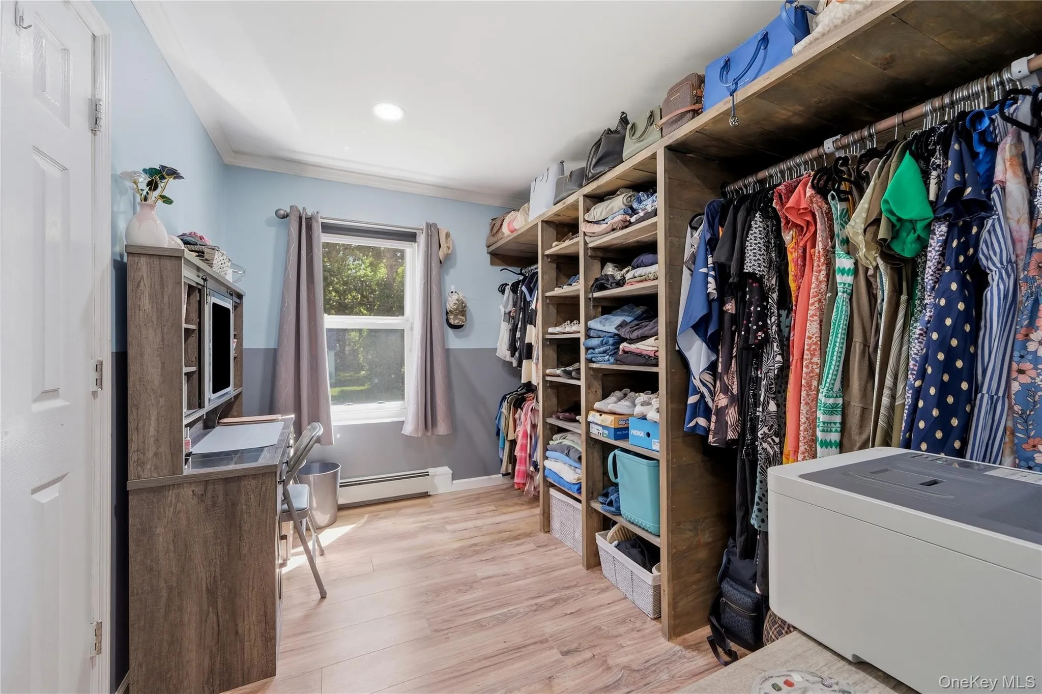 Custom storage system featuring shelving and hanging rods Custom storage system featuring shelving and hanging rods