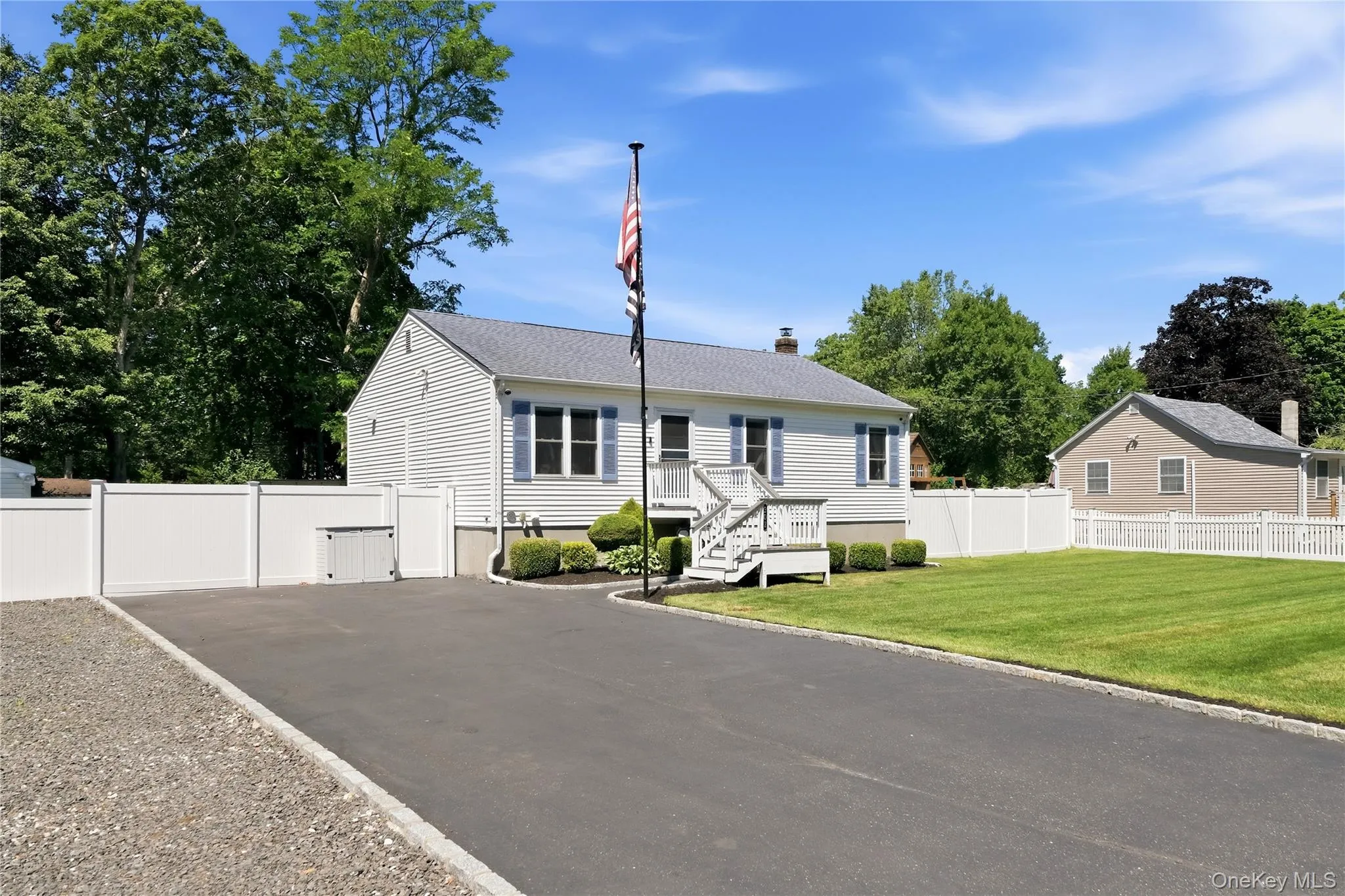 Ranch-style home featuring white siding and blue shutters Ranch-style home featuring white siding and blue shutters