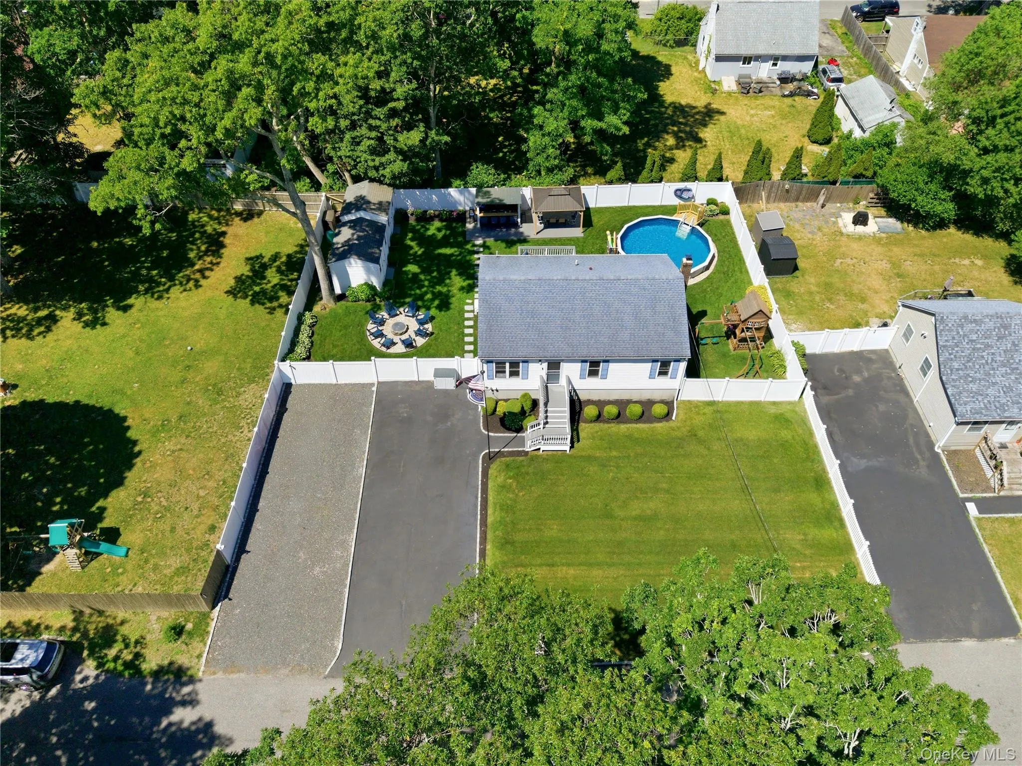 Single-story residence featuring a gray shingle roof and white siding Single-story residence featuring a gray shingle roof and white siding