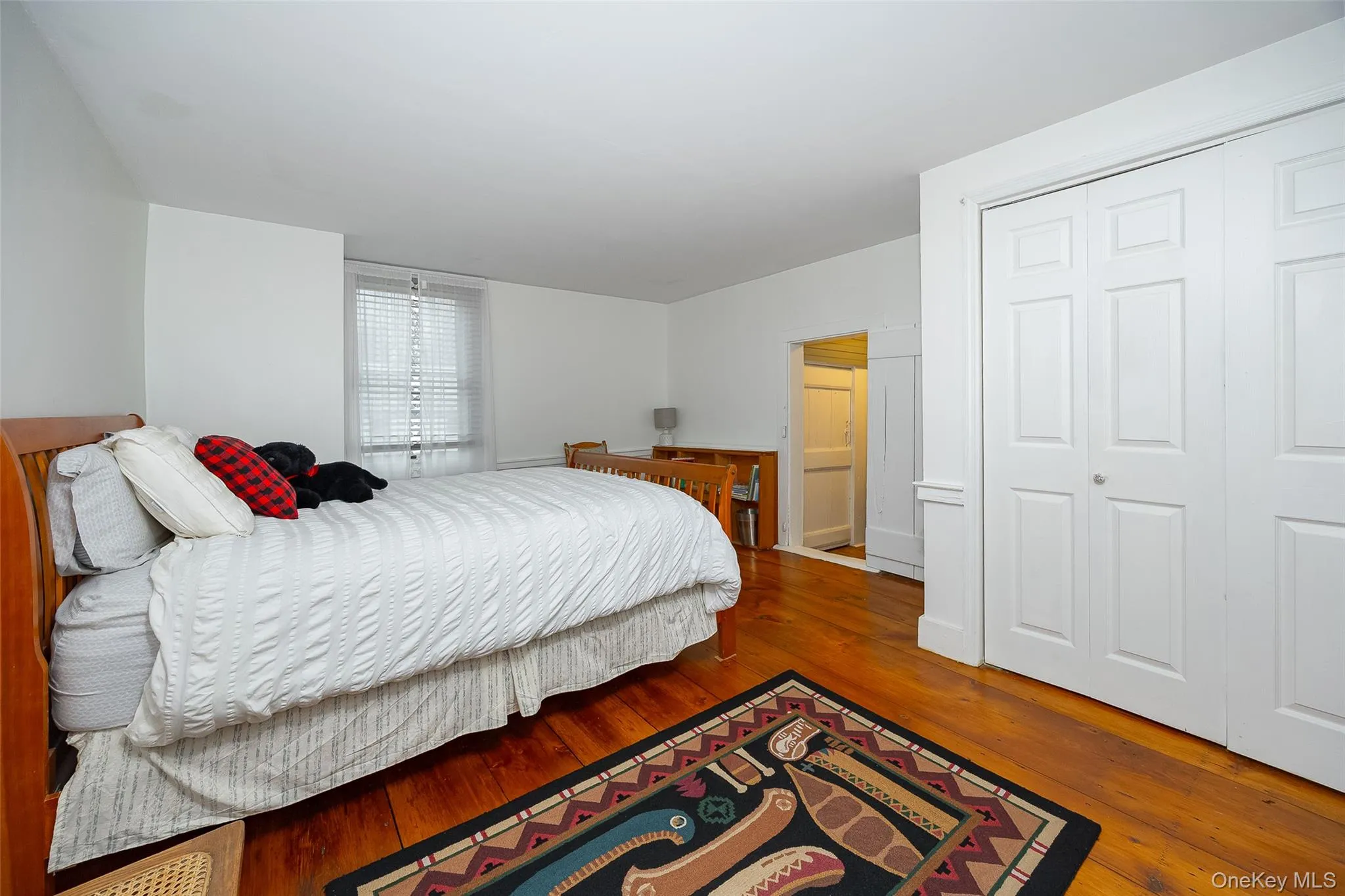 Bedroom with hardwood / wood-style flooring and a closet Bedroom with hardwood / wood-style flooring and a closet