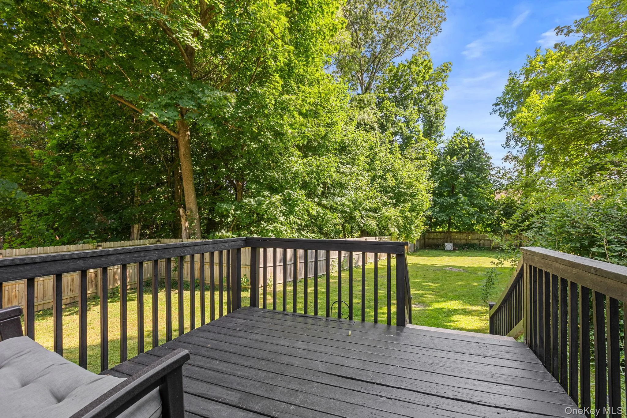 Spacious wooden deck with dark finish Spacious wooden deck with dark finish