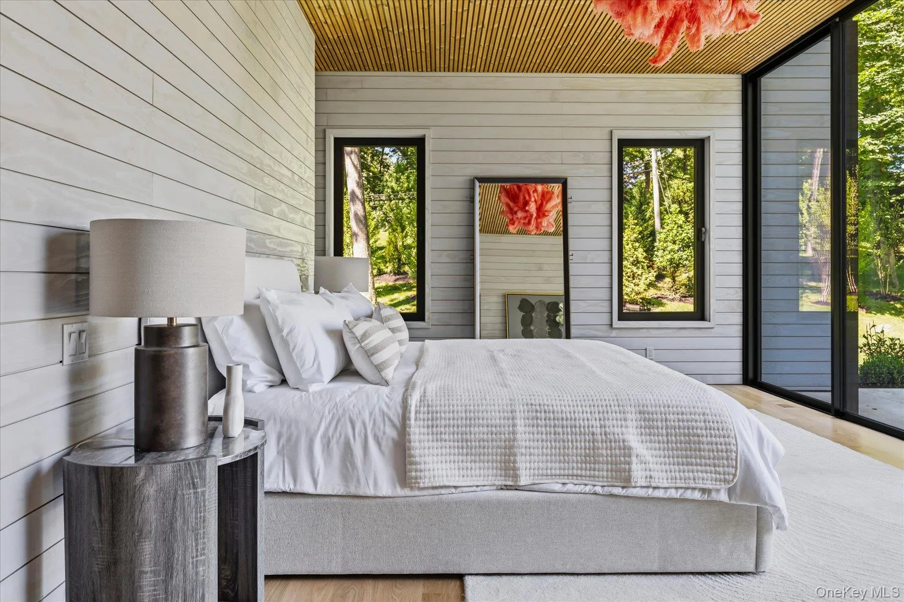 First floor primary bedroom with floor to ceiling windows, access to outdoor terrace, large walk-in closet and en suite bath First floor primary bedroom with floor to ceiling windows, access to outdoor terrace, large walk-in closet and en suite bath