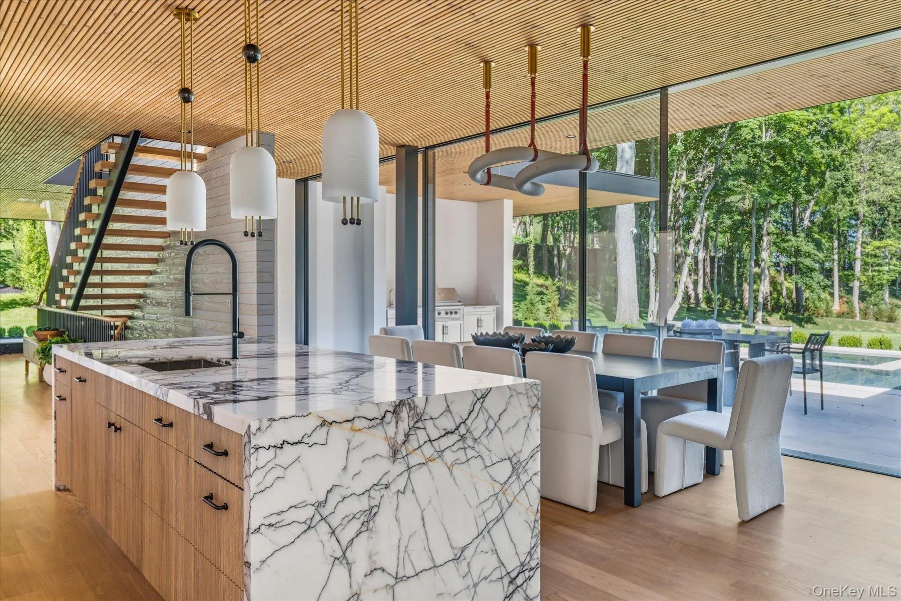 Open Concept Kitchen and Dining with seamless indoor/outdoor entertaining capturing water views Open Concept Kitchen and Dining with seamless indoor/outdoor entertaining capturing water views