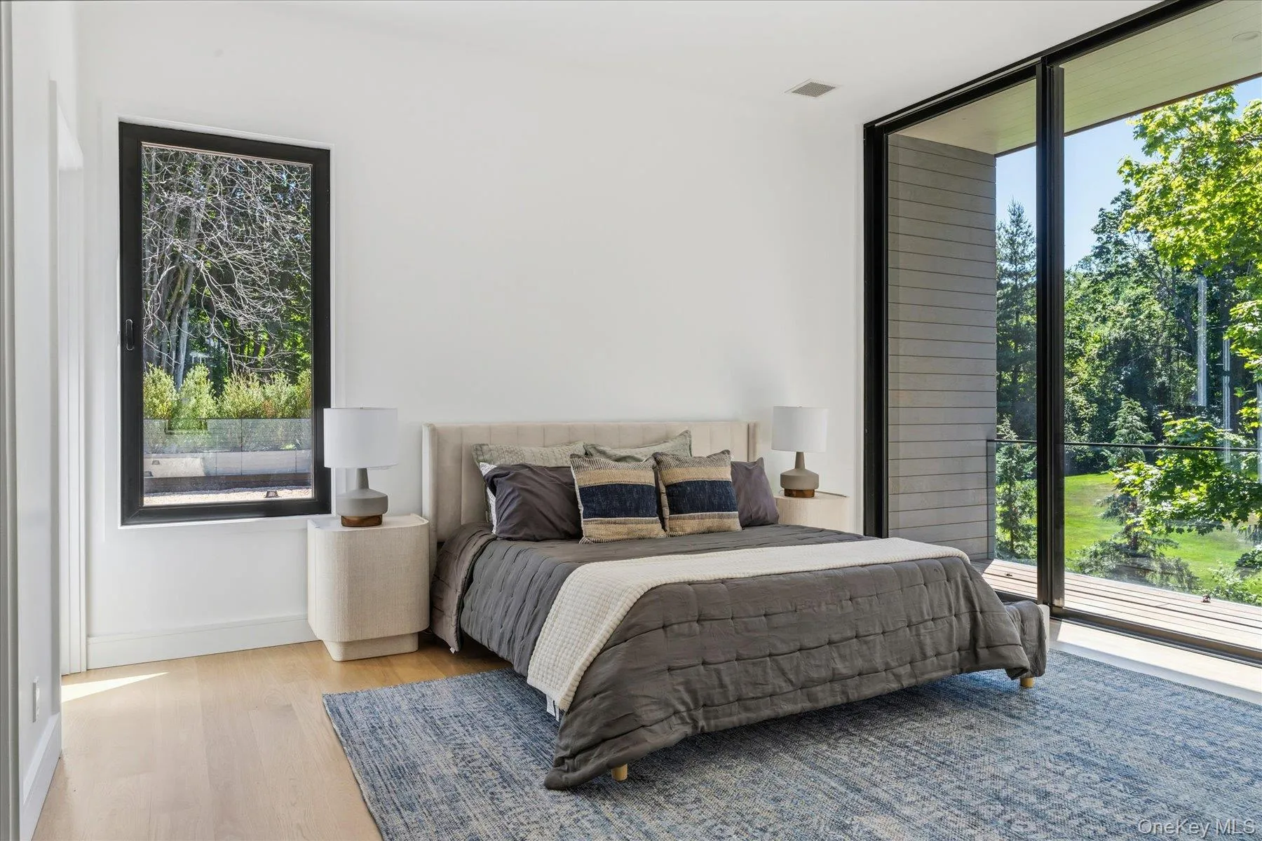 Bedroom with en suite bath, expansive floor to ceiling windows with outdoor access to balcony Bedroom with en suite bath, expansive floor to ceiling windows with outdoor access to balcony