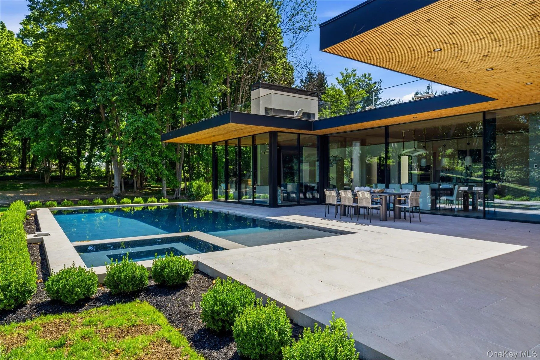Expansive outdoor terrace with pool, outdoor seating and outdoor kitchen Expansive outdoor terrace with pool, outdoor seating and outdoor kitchen