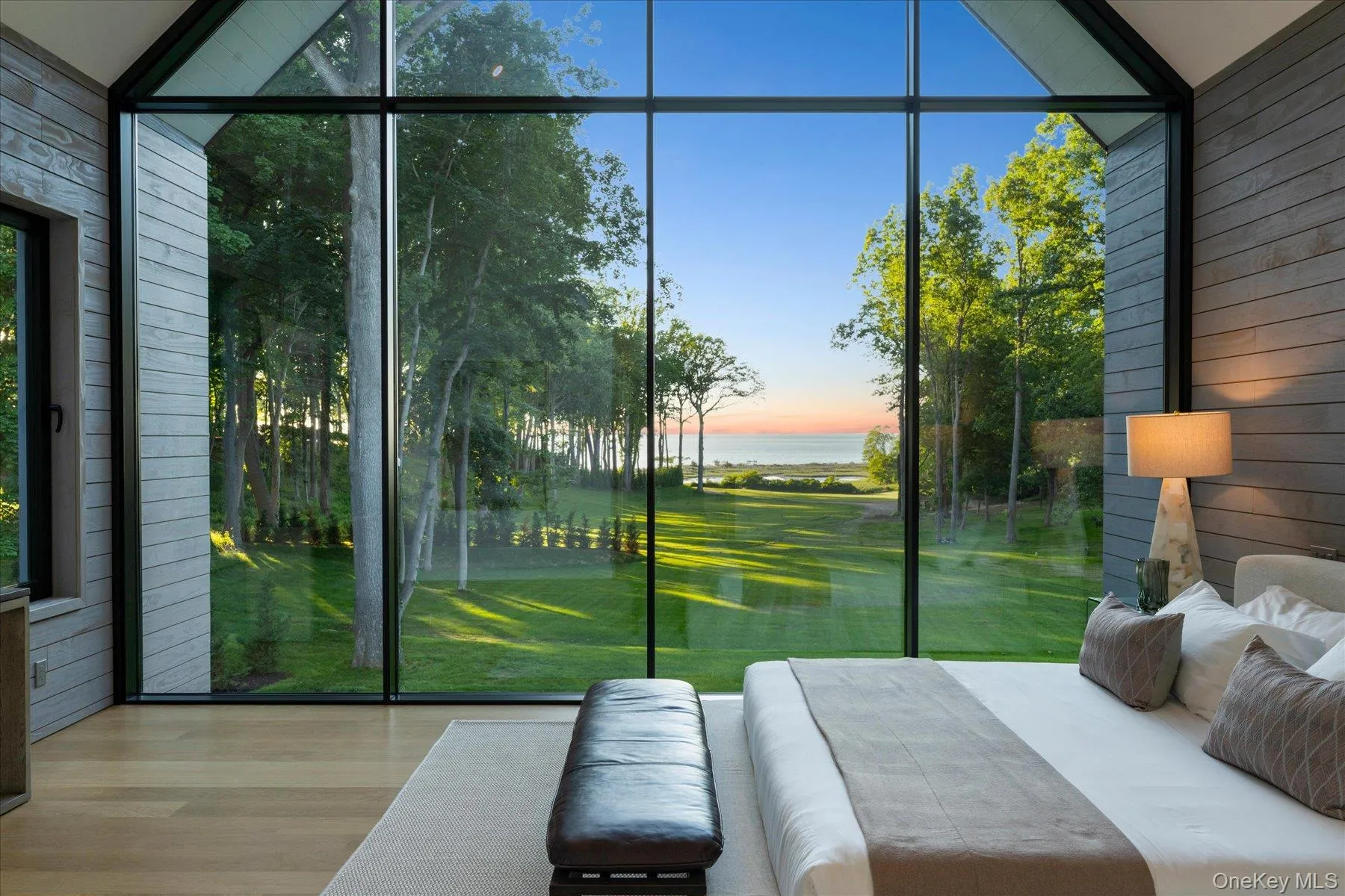 Second floor primary bedroom with stunning floor to ceiling windows and water views Second floor primary bedroom with stunning floor to ceiling windows and water views