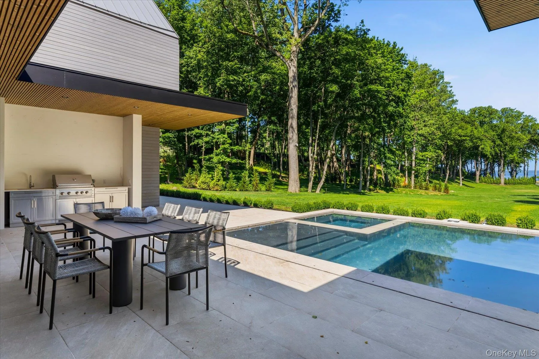 Outdoor kitchen and dining, resort style swimming pool and water views Outdoor kitchen and dining, resort style swimming pool and water views