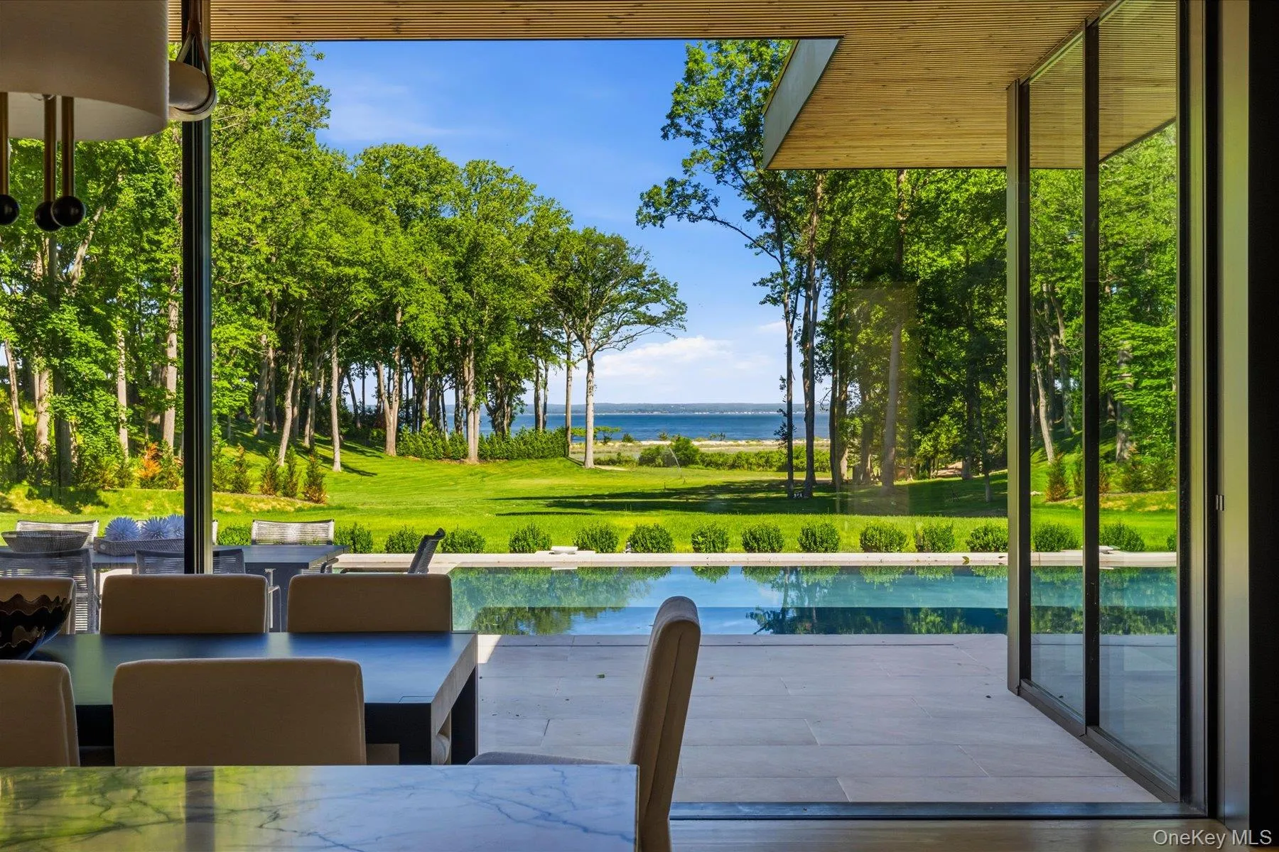 Water views and pool access through retractable glass Water views and pool access through retractable glass