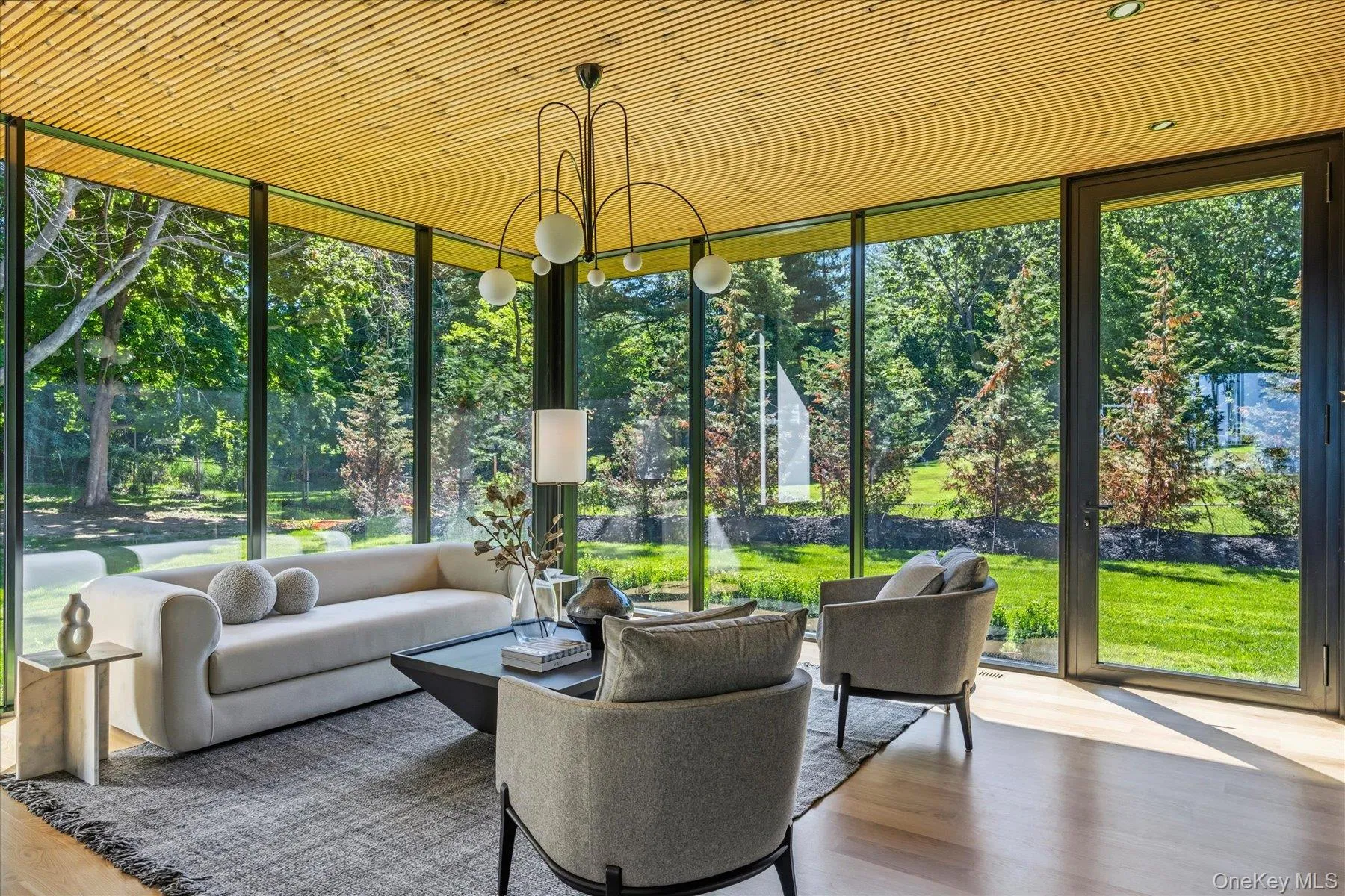 Den with floor to ceiling windows and custom built-ins and outdoor access. Den with floor to ceiling windows and custom built-ins and outdoor access.