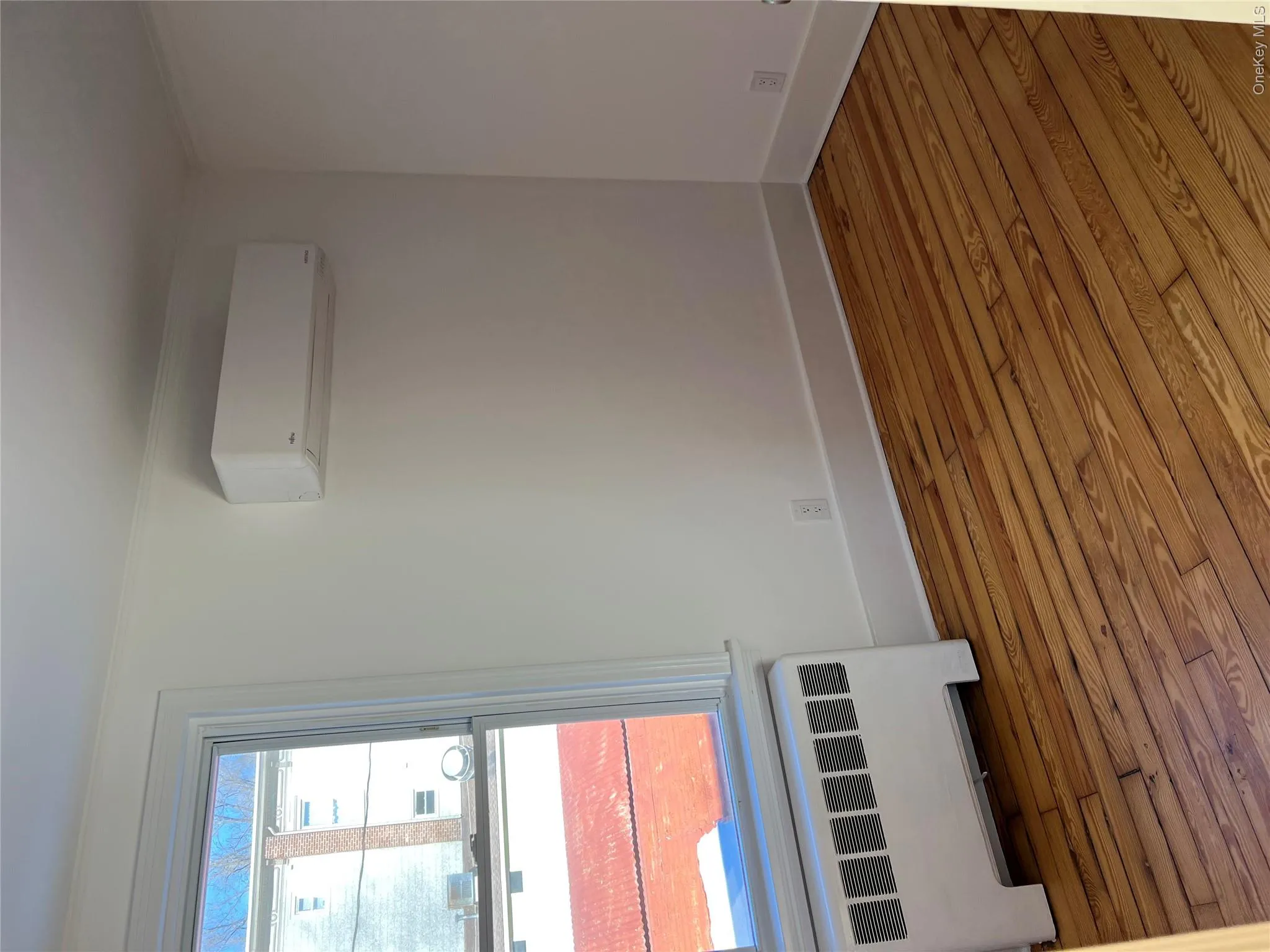 Apartment #1 Bedroom with wood floors and mini split Apartment #1 Bedroom with wood floors and mini split